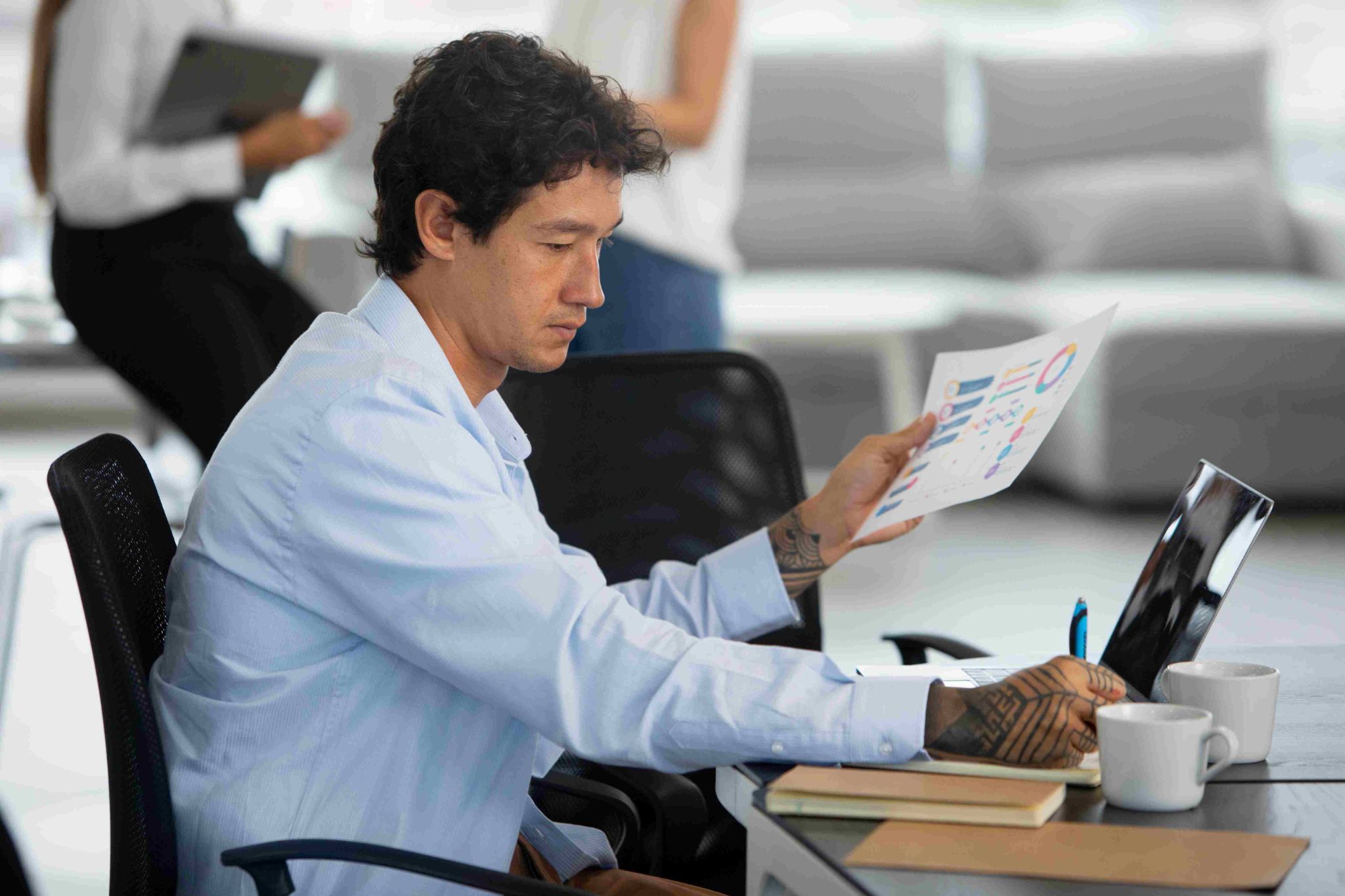 Man looking at a document at a desk