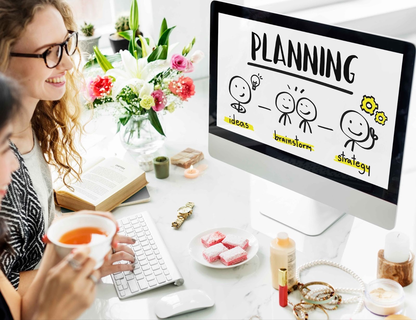 Woman looking at a laptop with PLANNING on the screen