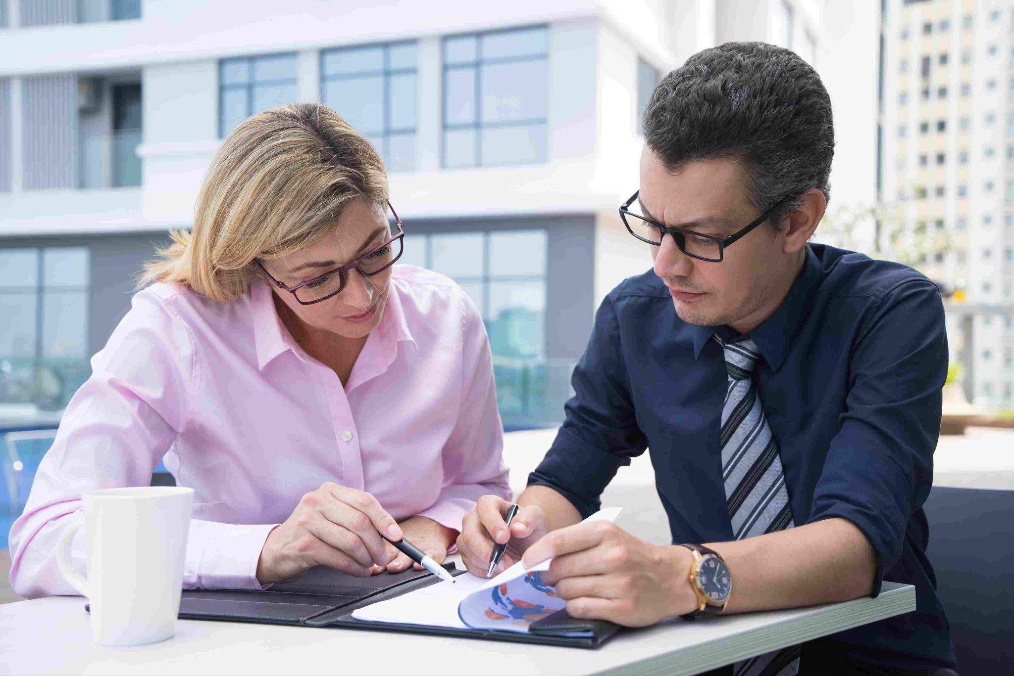 Two business professionals reviewing documents