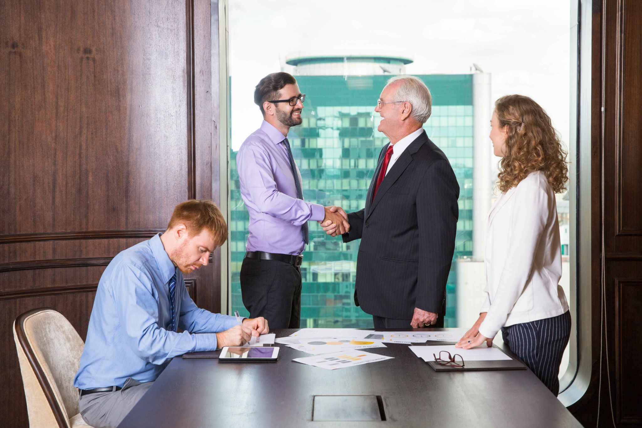 People shaking hands in a meeting room