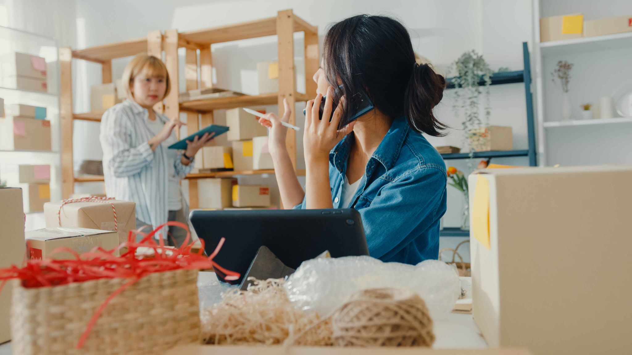 Woman talking on phone in a warehouse office setting