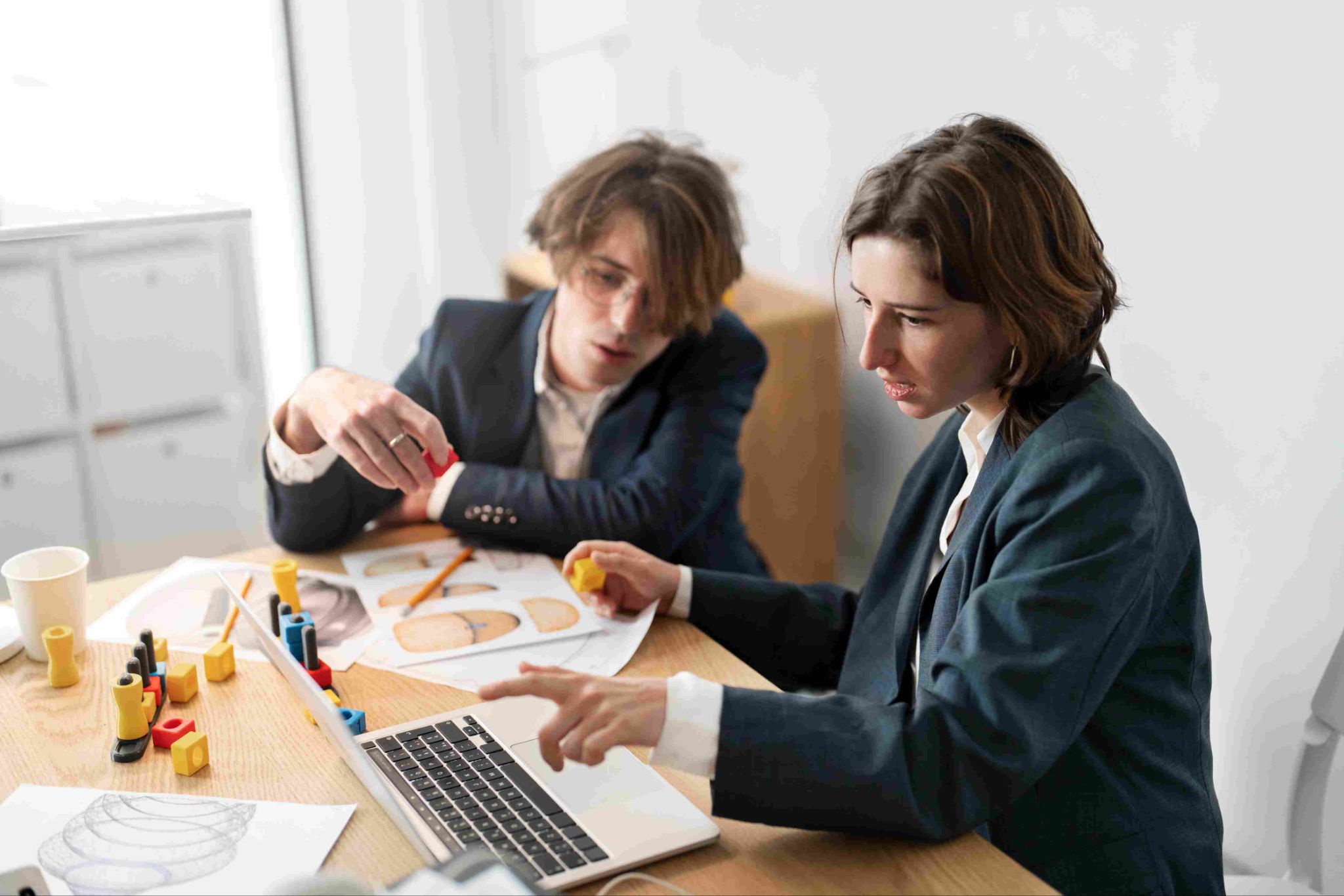 Two people discussing shift swaps over paperwork