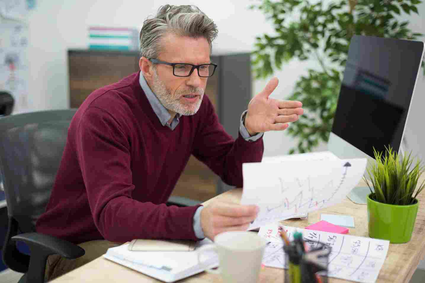 Business professional looking at his watch in a modern office environment