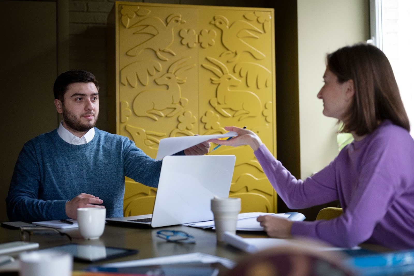 Two people discussing at a laptop