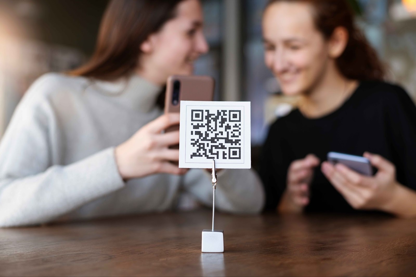 Employees using a QR code stand to clock in