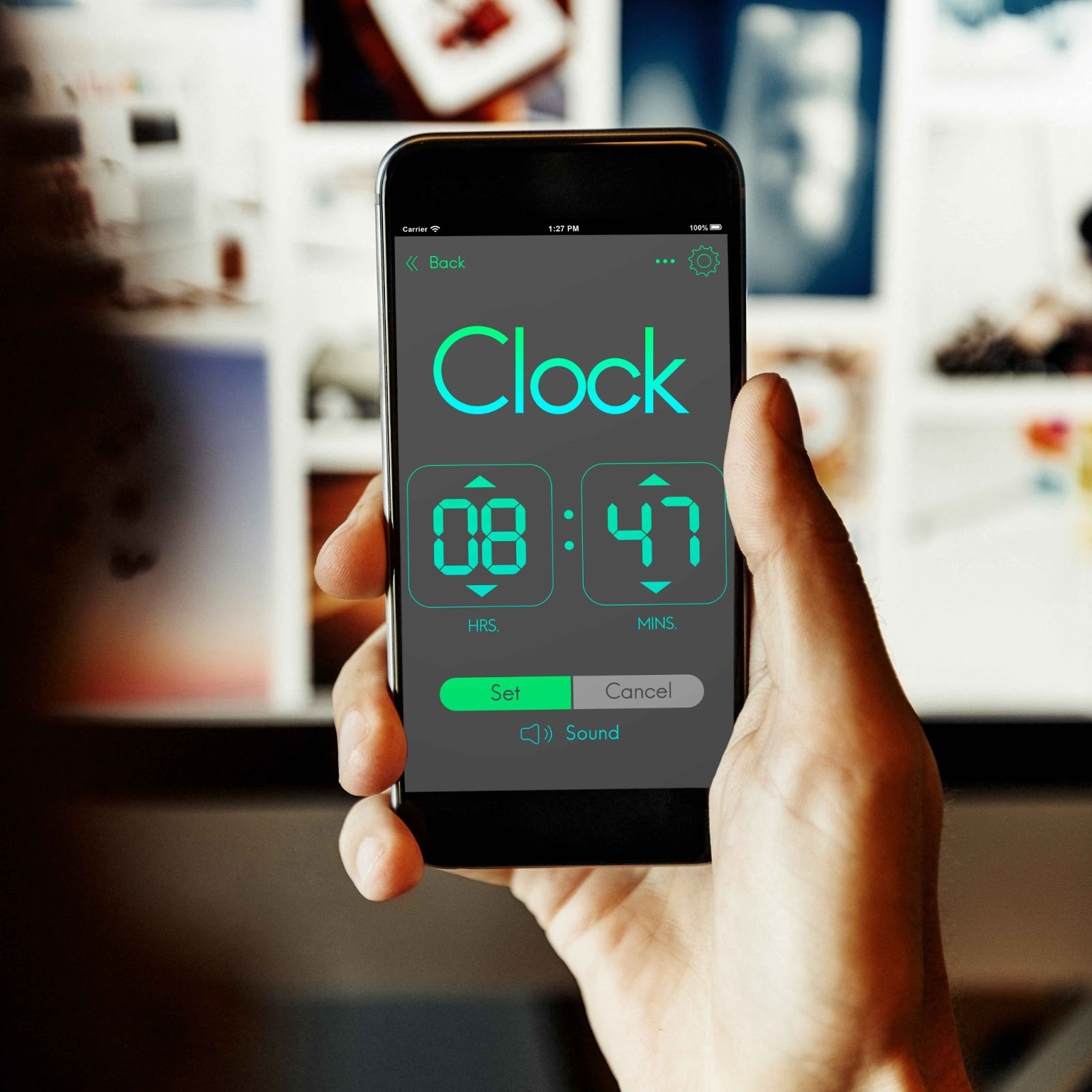 Person holding a smartphone displaying a digital clock app interface