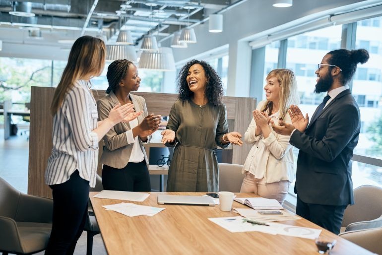 Team members clapping and celebrating workplace success
