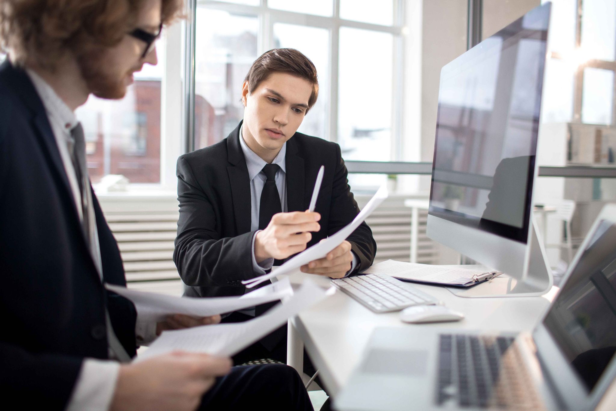 Law firm professionals reviewing documents in an office