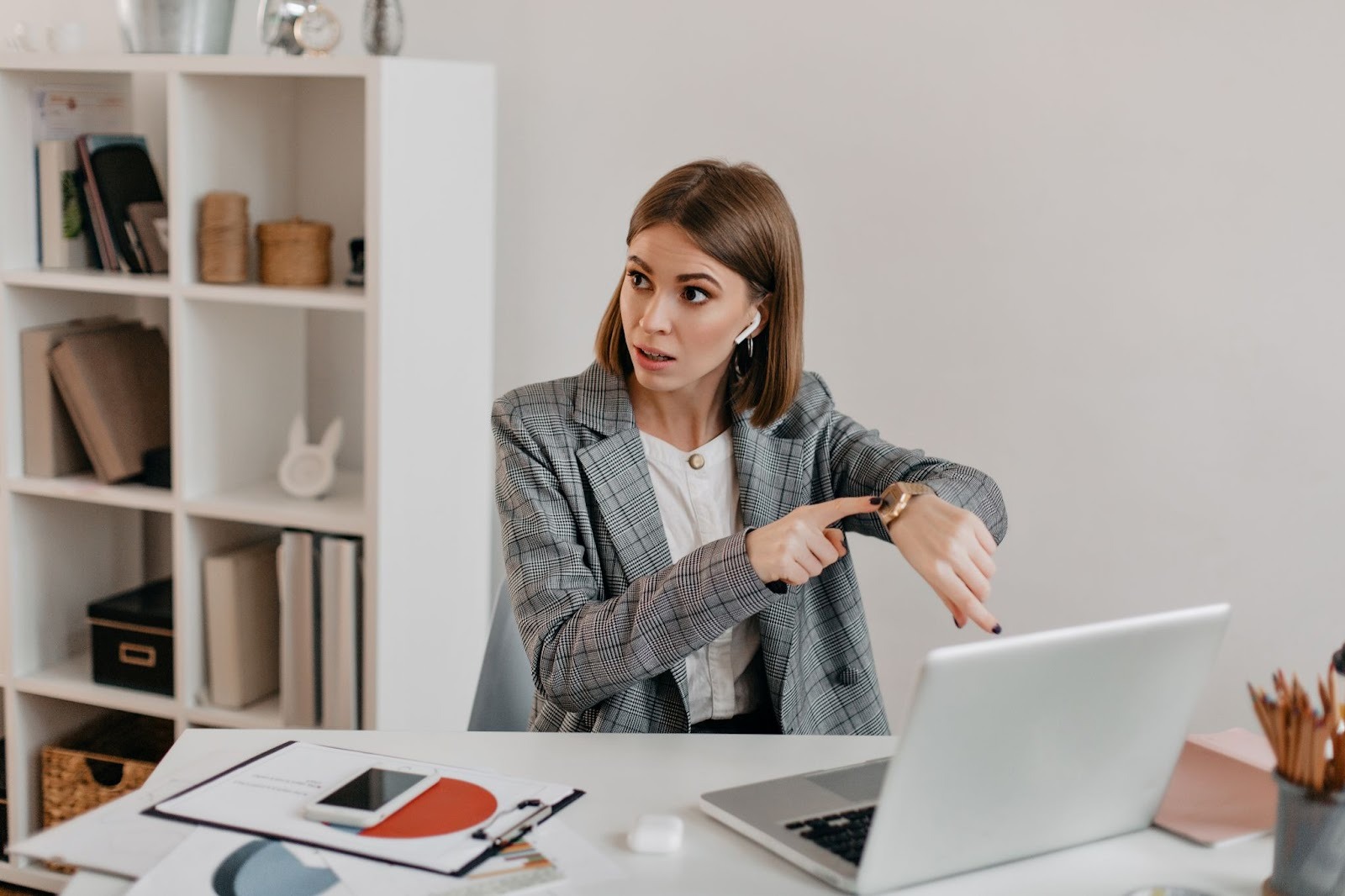Woman pointing at her watch urgently