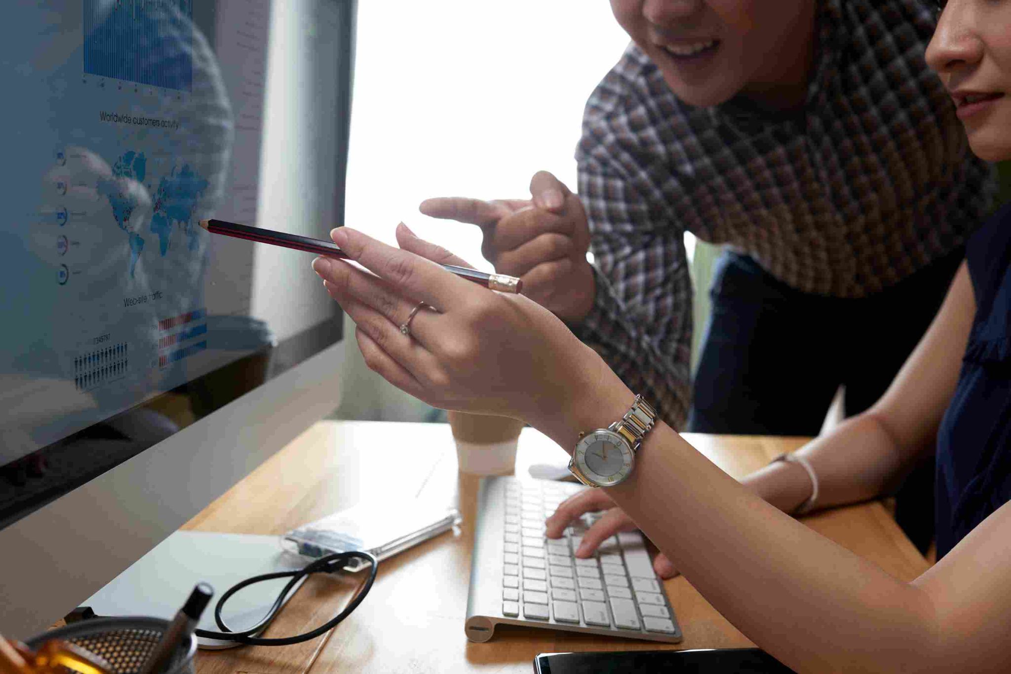 People gathered around a computer discussing