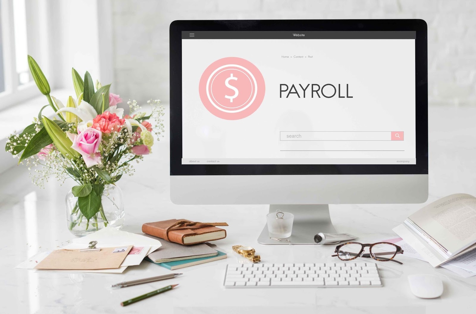 Computer screen displaying payroll interface on a desk