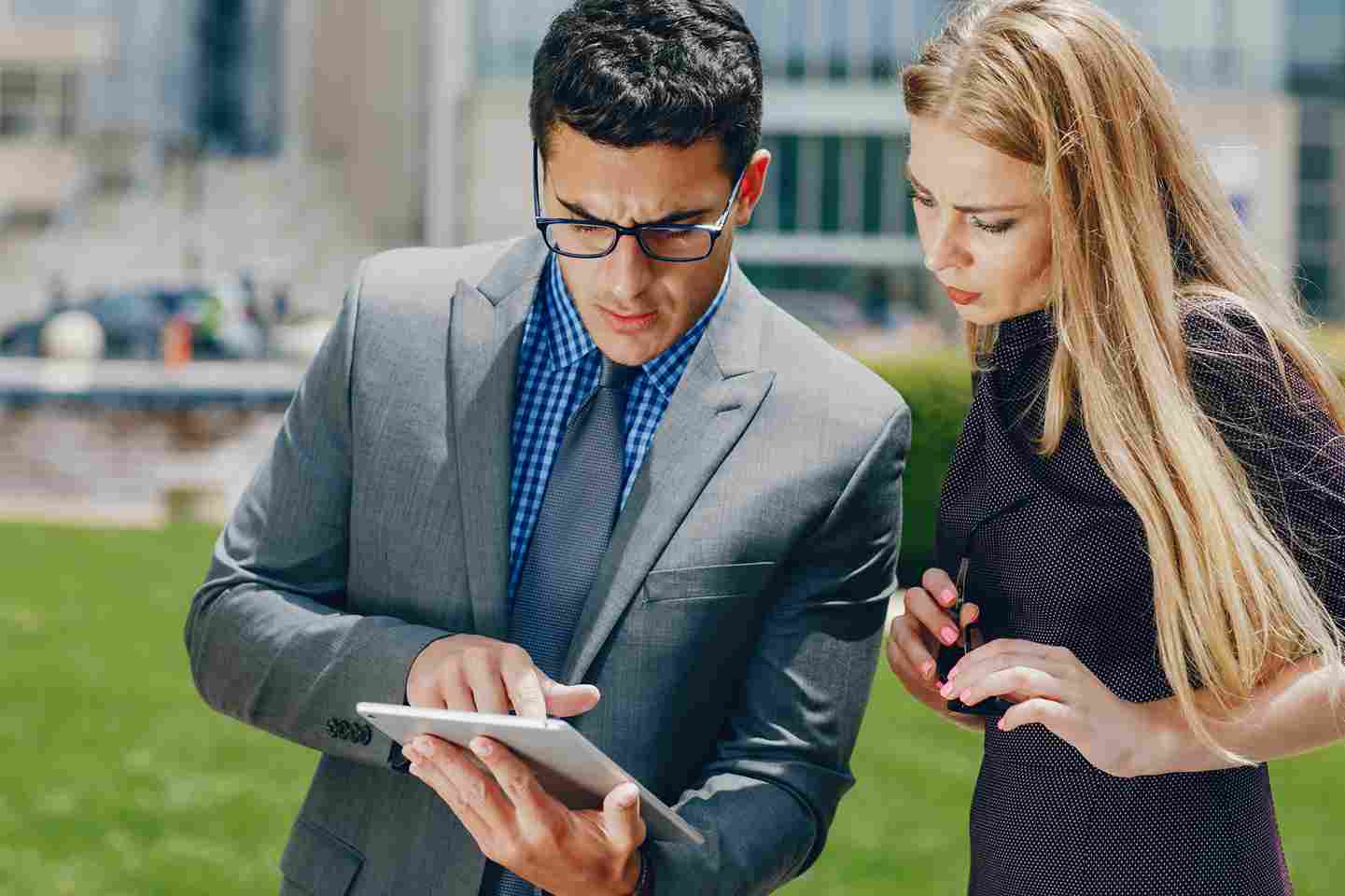 Two people looking at a tablet