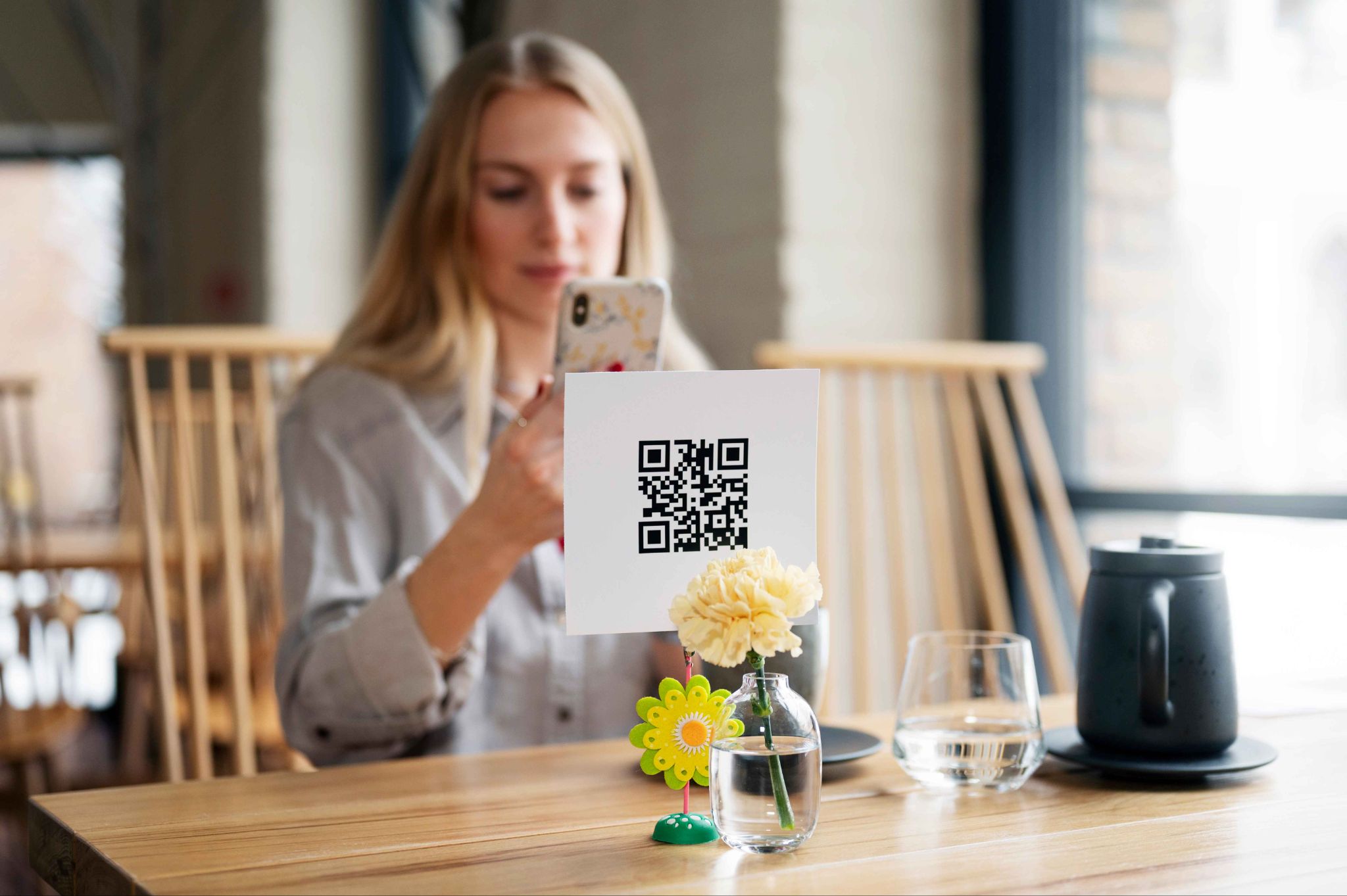 Employee scanning QR code at a table