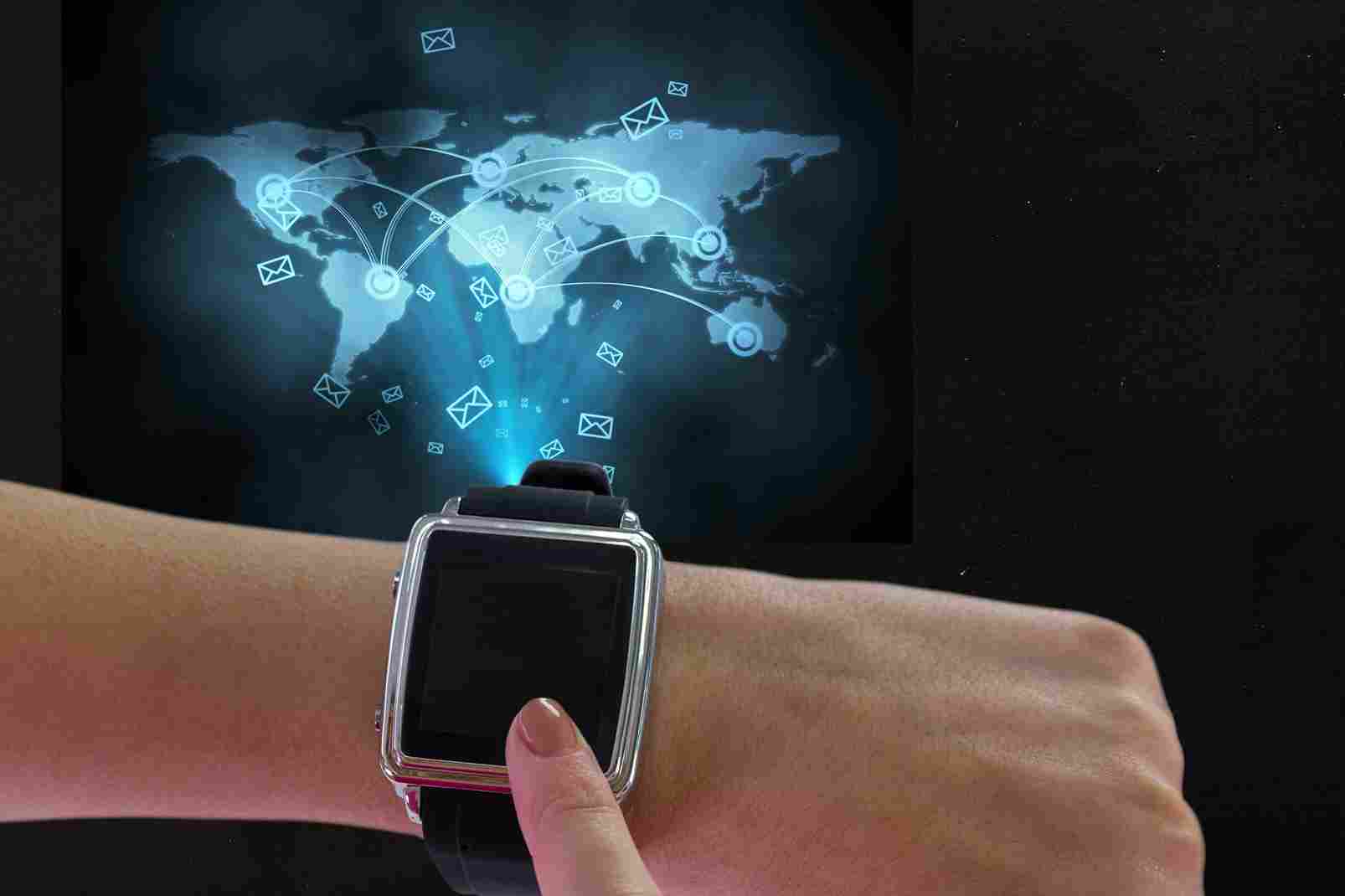 Smartwatch scanning a QR code over a glowing world map