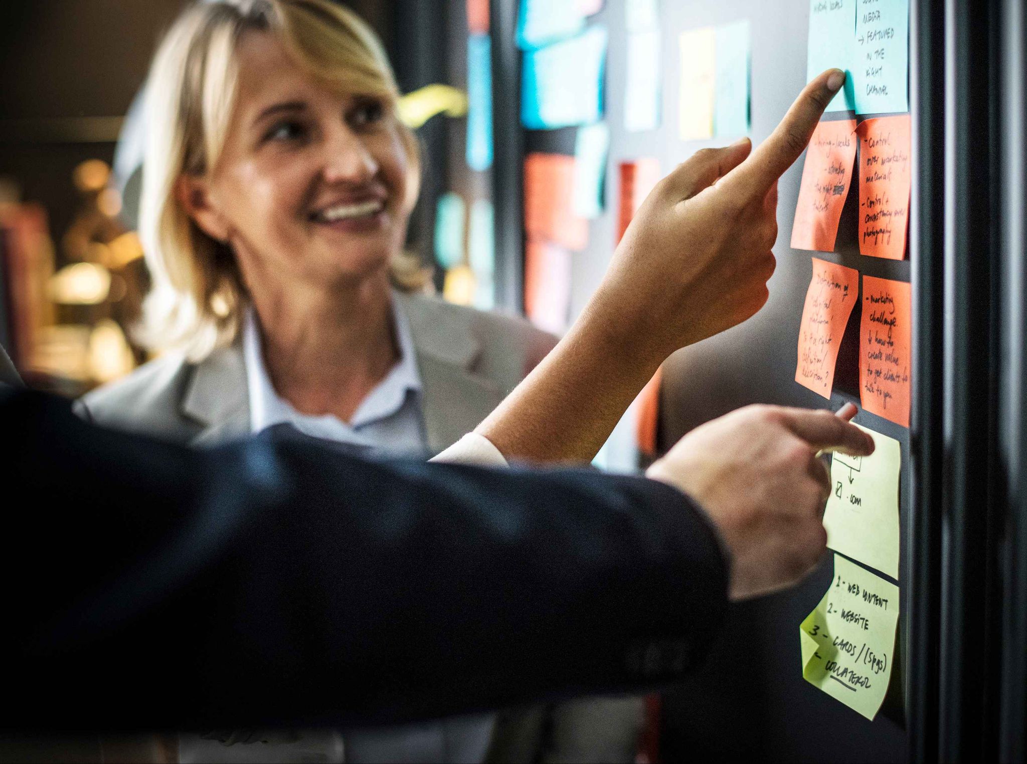 Retail managers organizing employee availability with sticky notes