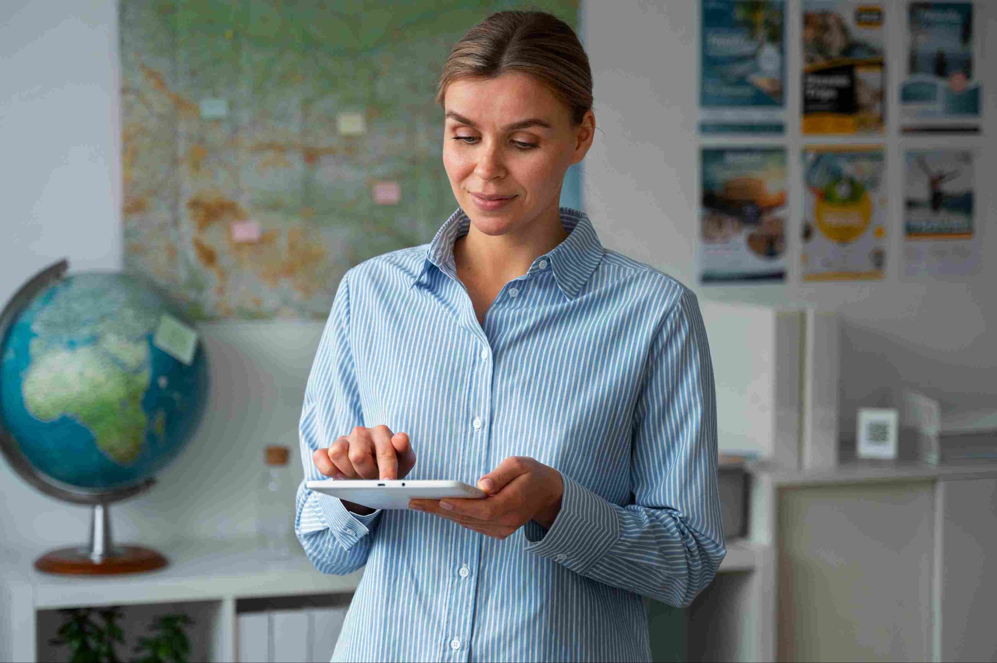 Woman standing in a classroom holding a tablet