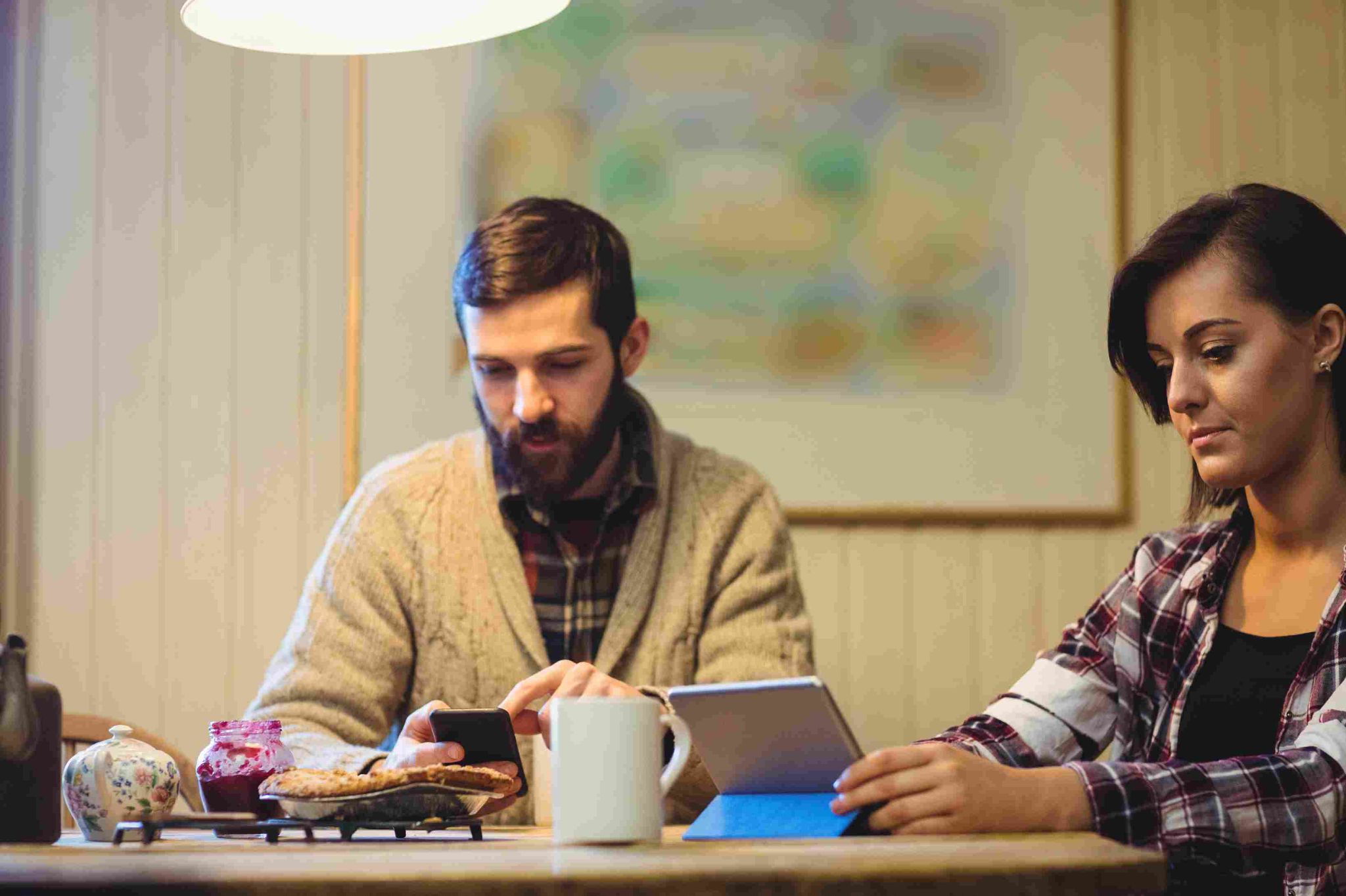 A man and woman looking at a laptop/tablet