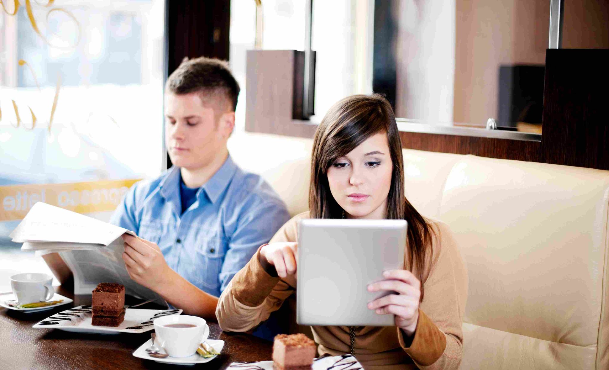 Employees using a shared tablet to clock in