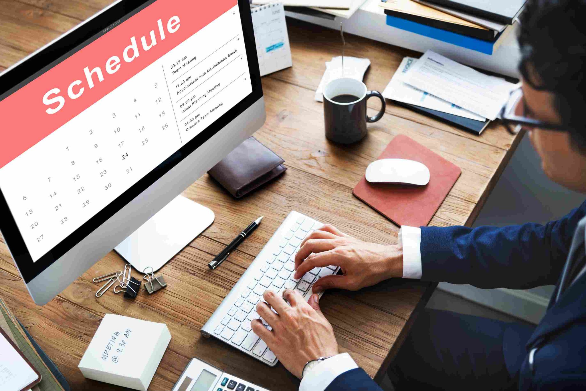 Manager using shift scheduling software on a computer