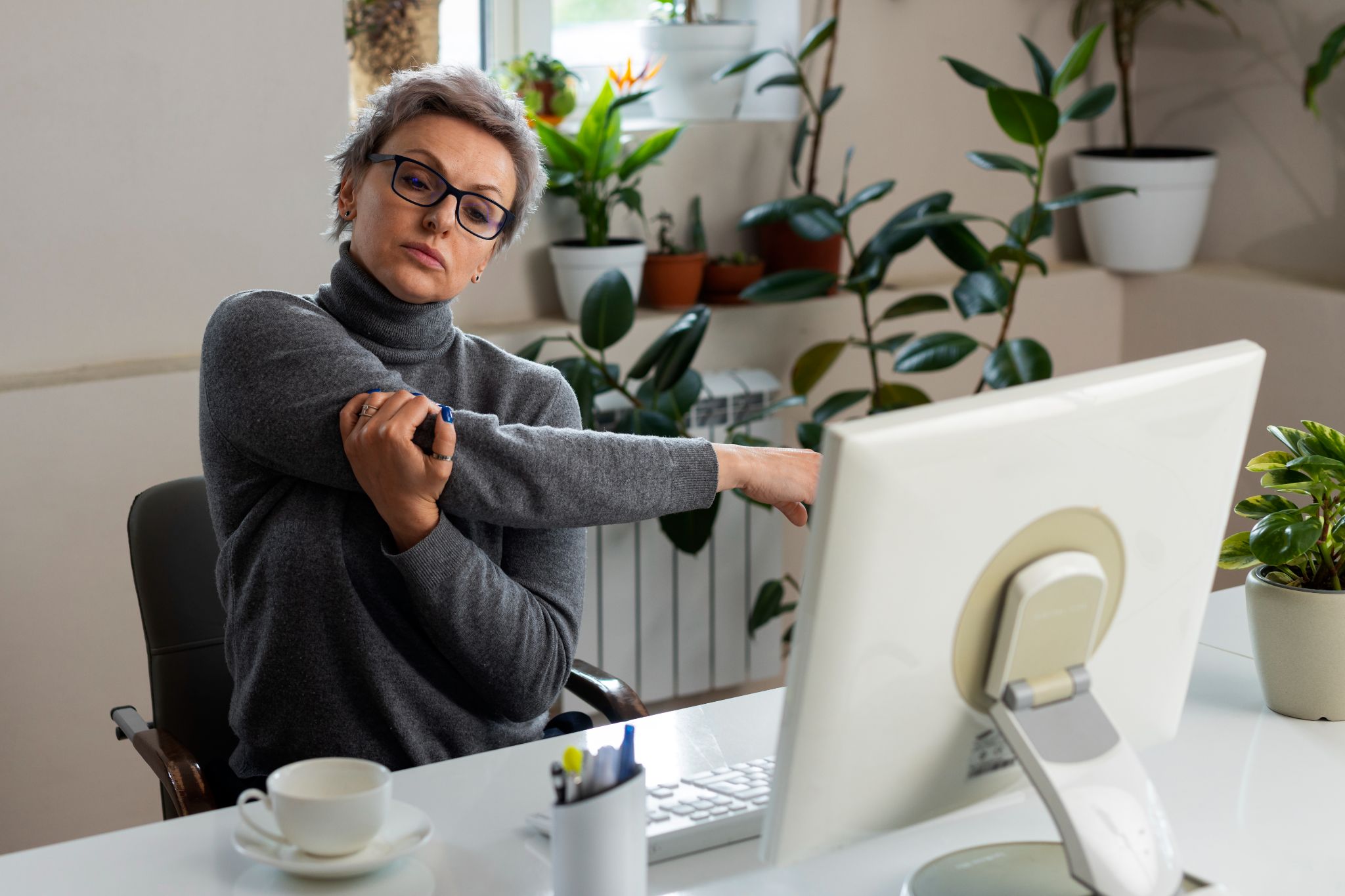 Frustrated woman at a computer struggling with manual sick leave tracking