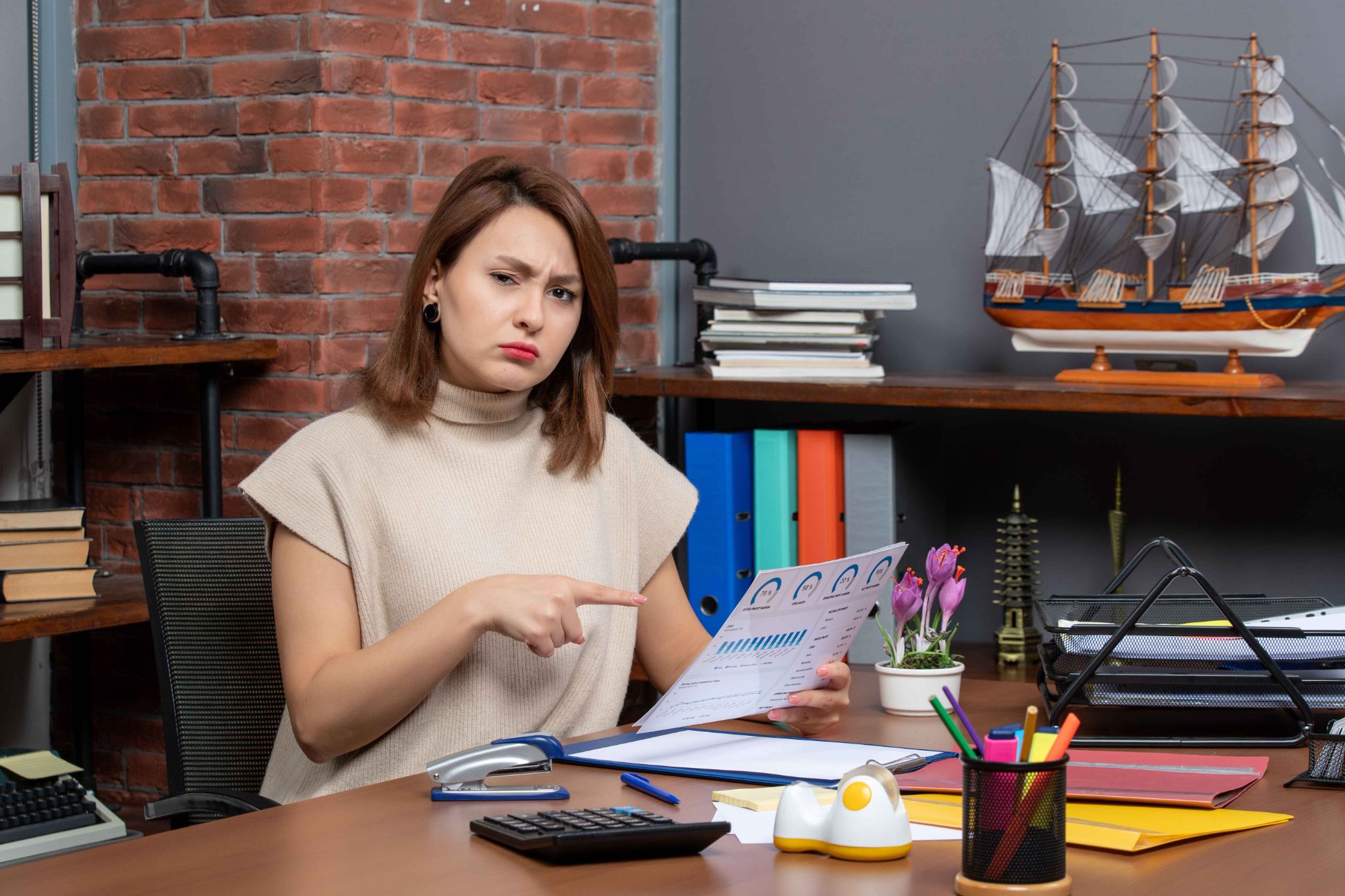 Frustrated woman pointing at attendance report