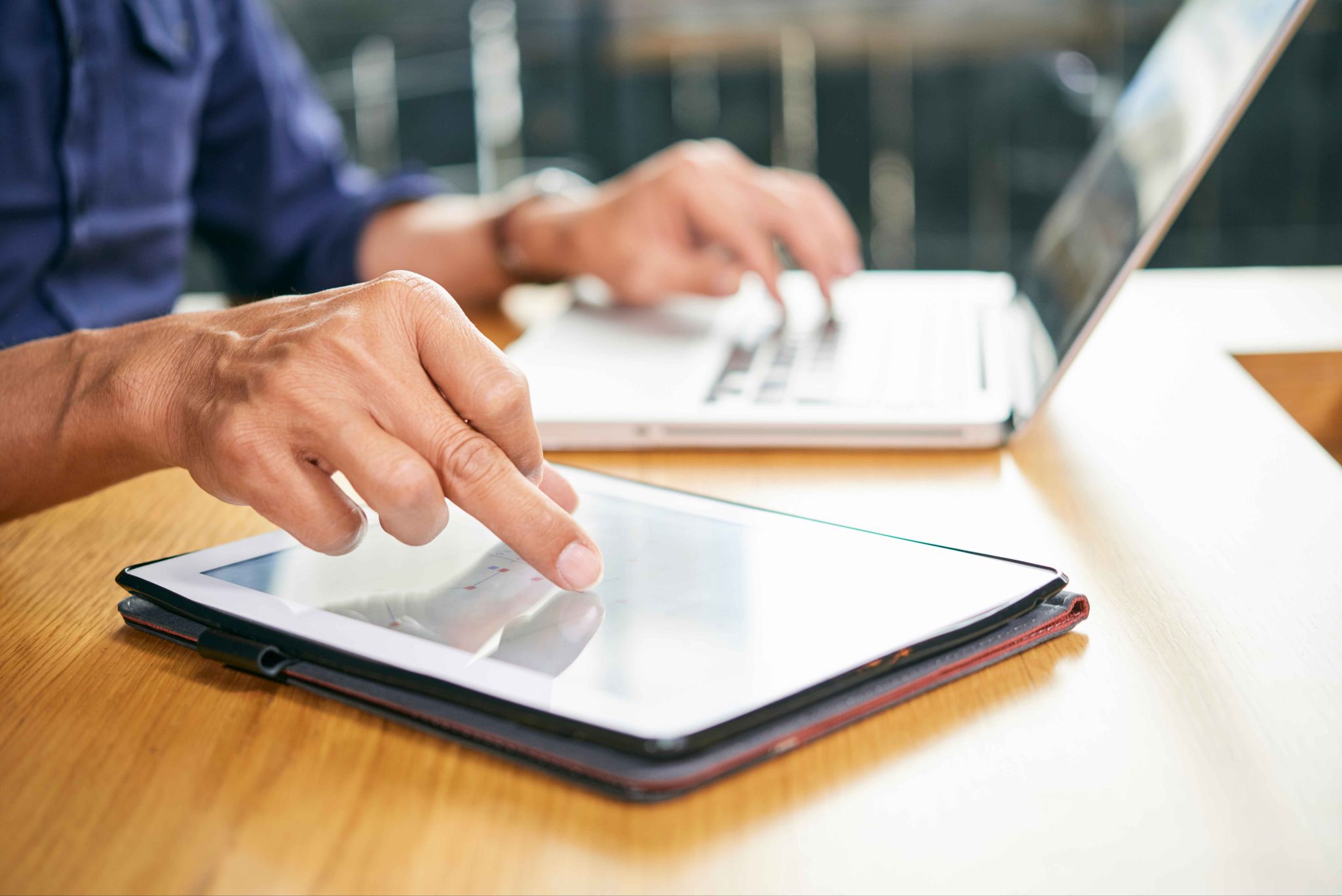 Person using a tablet for digital signatures and compliance
