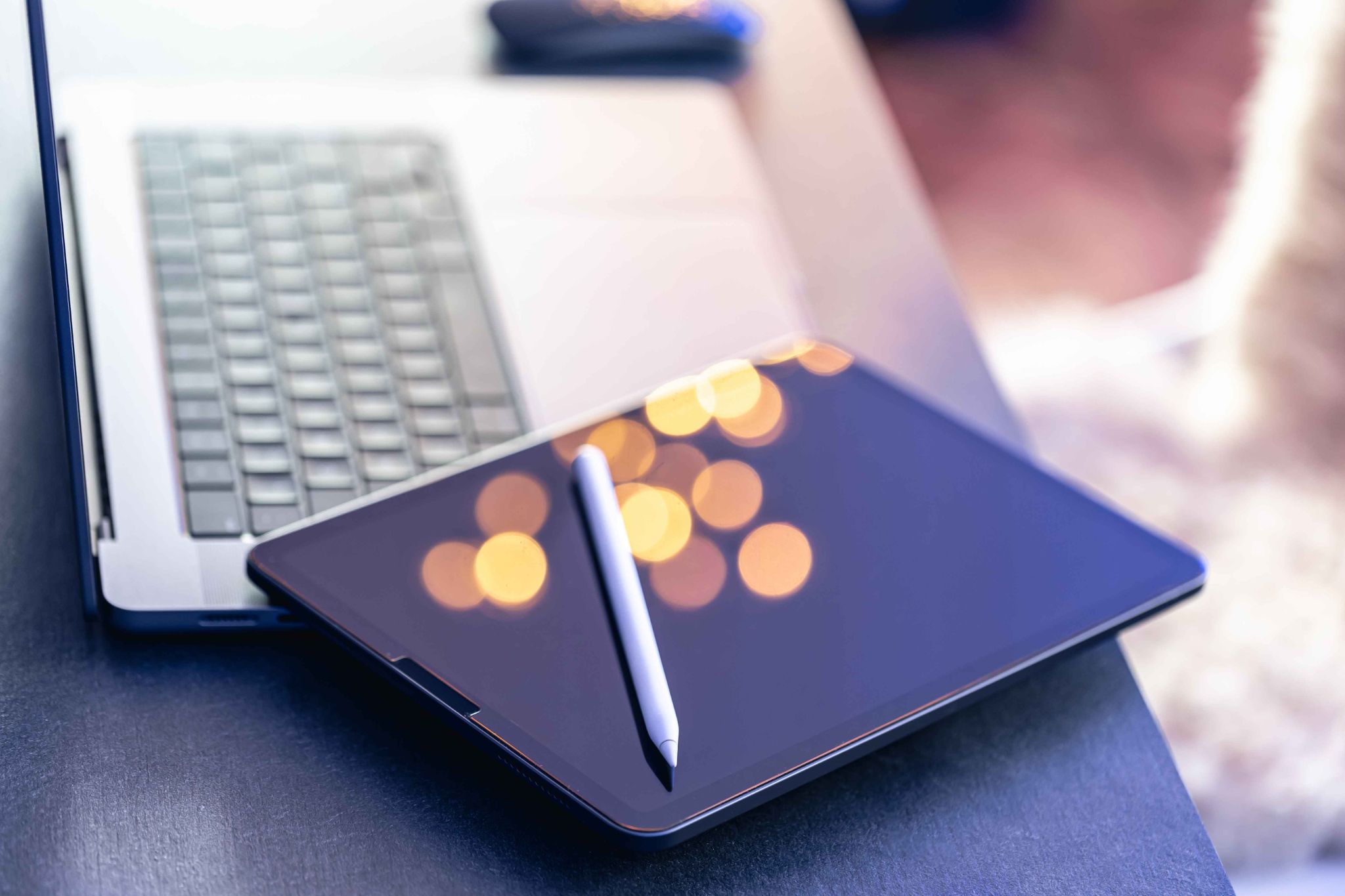 Digital pen resting on a tablet computer