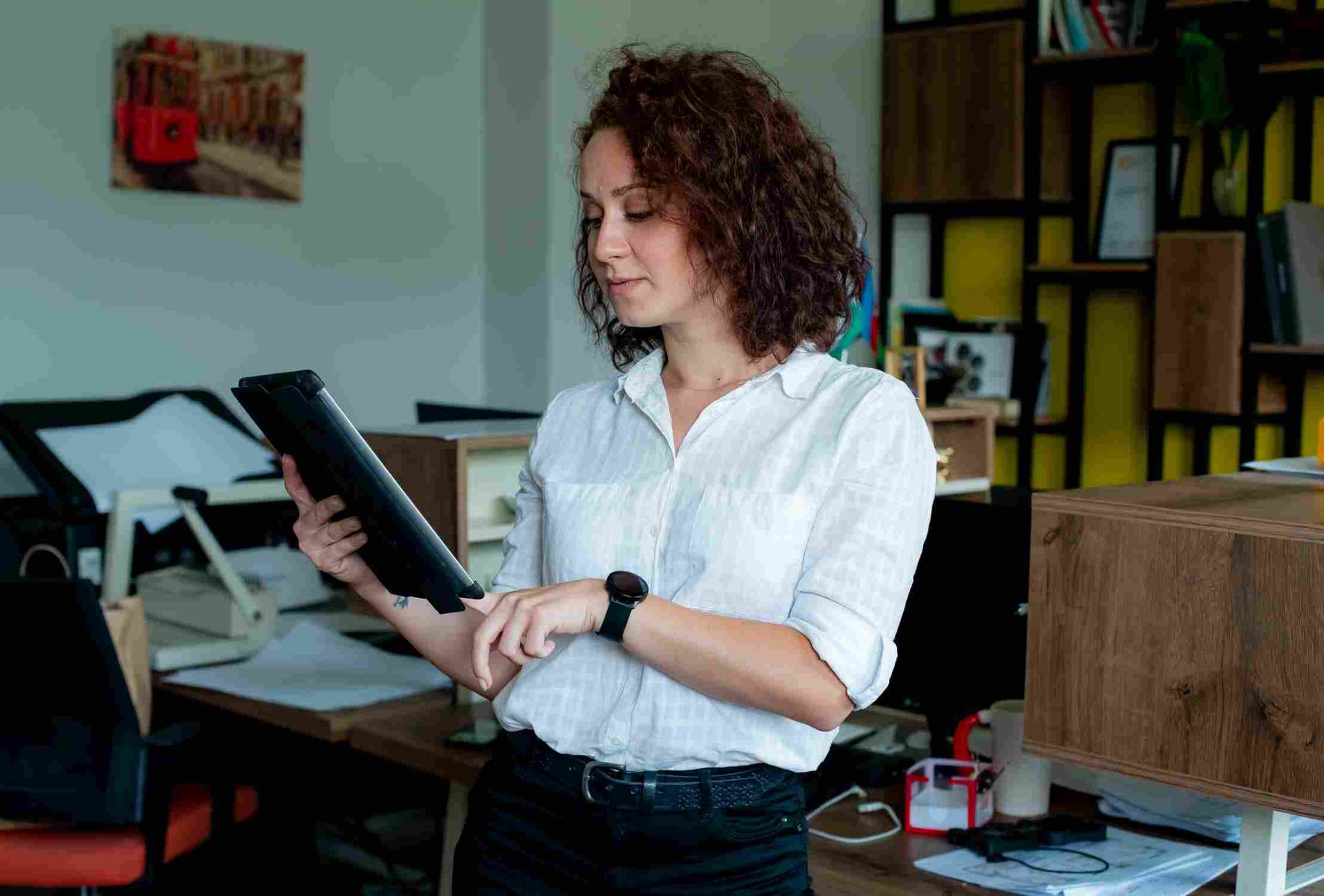 Person holding a tablet in a workplace