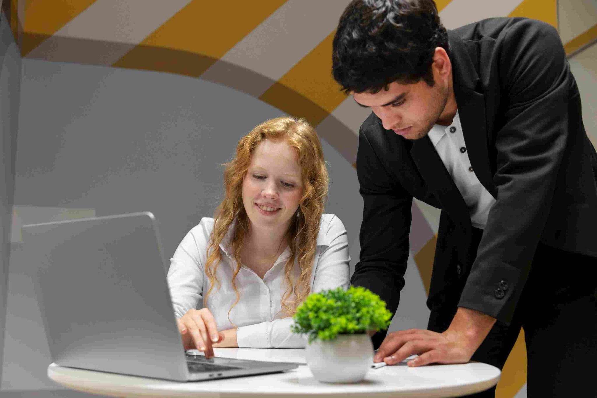 Two people looking at a laptop