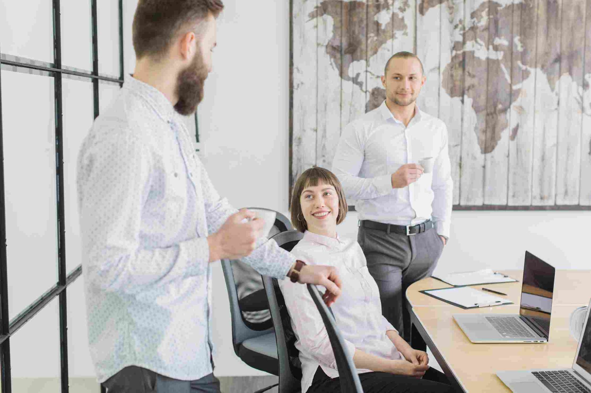 Three people in an office discussing