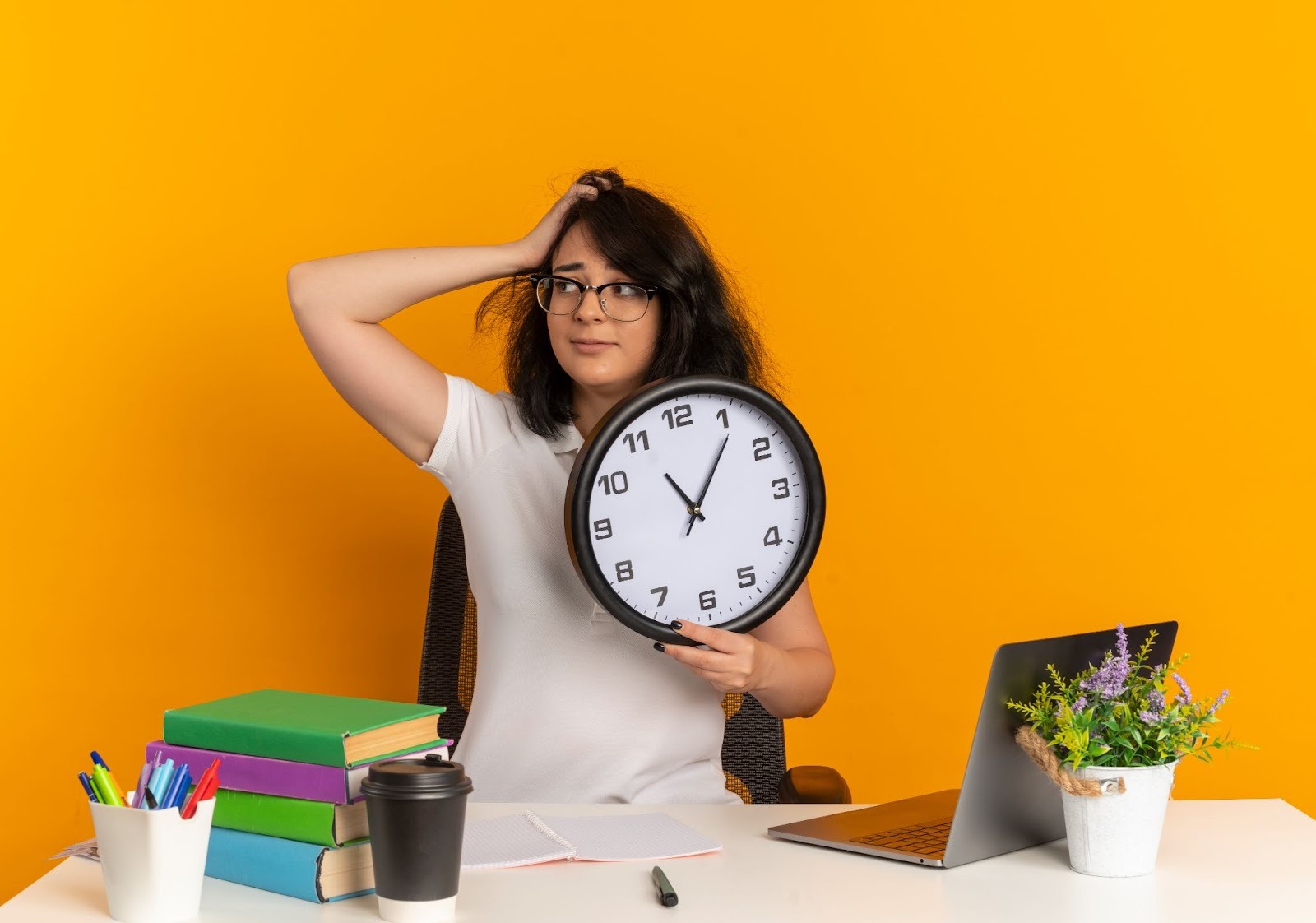 Frustrated woman holding a large clock