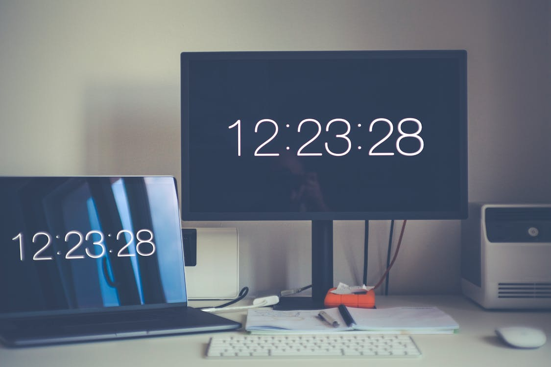 Time clock software displayed on office computer screens