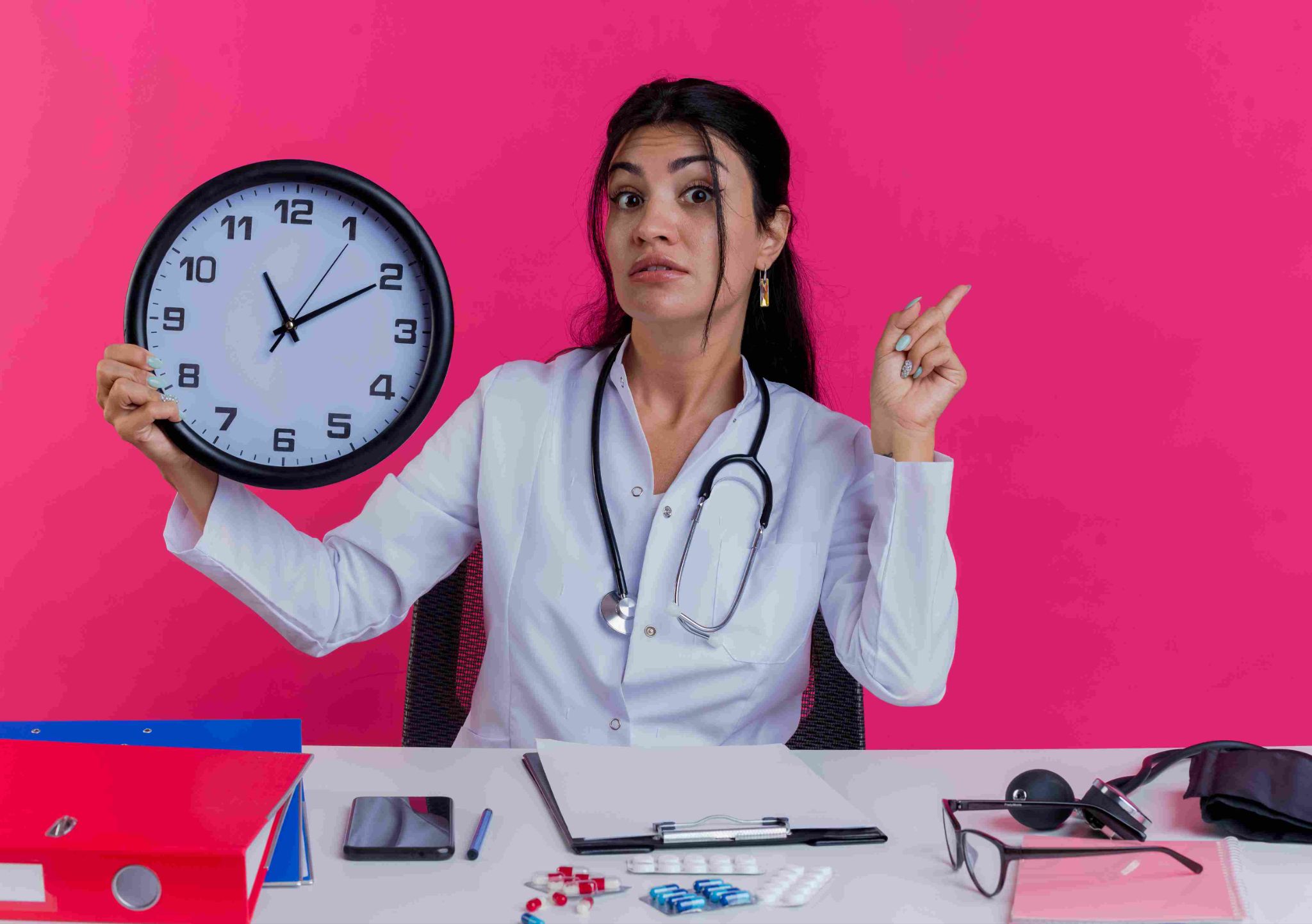Healthcare professional pointing at a clock