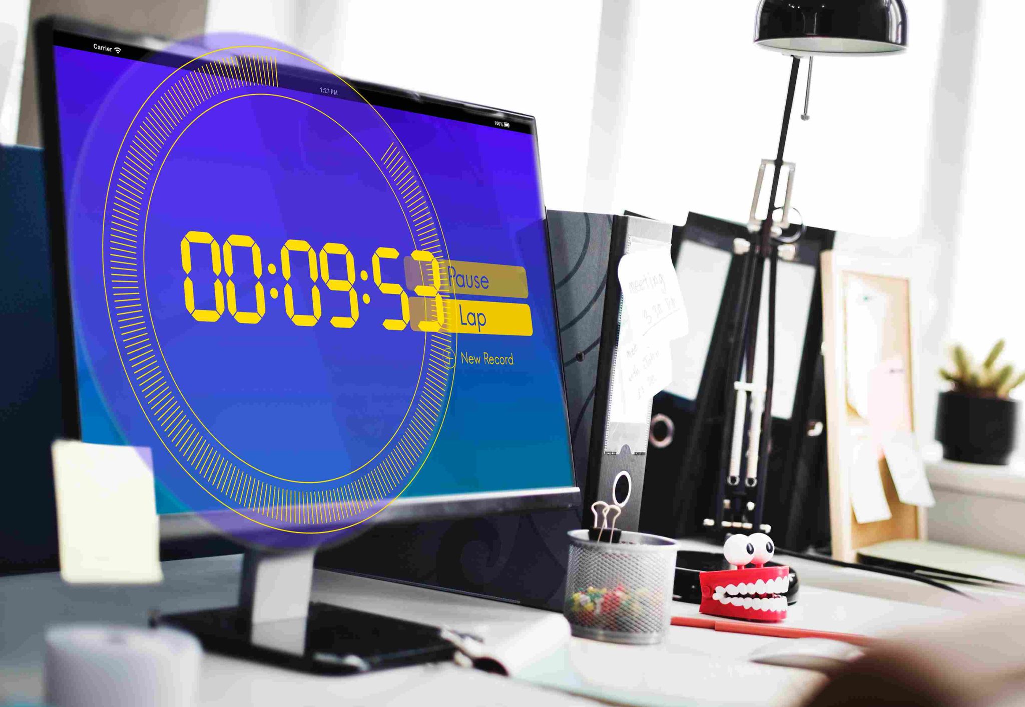 Computer screen showing a digital clock on a desk