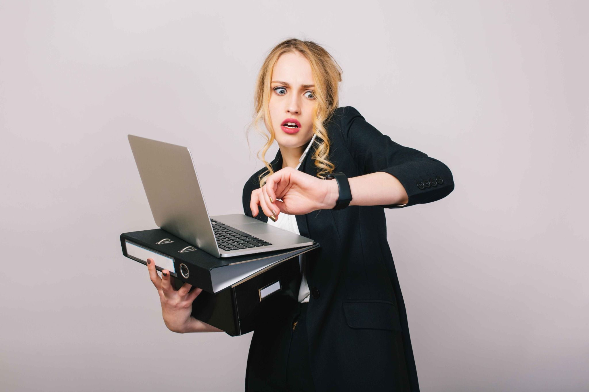Woman looking at watch in panic