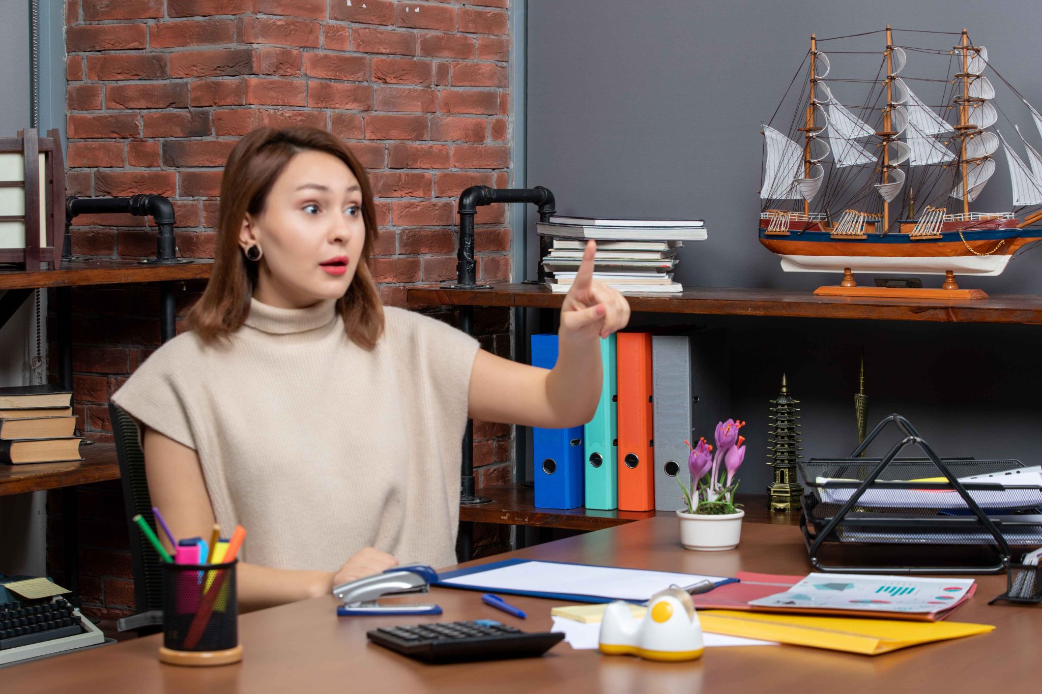 Woman pointing finger at desk