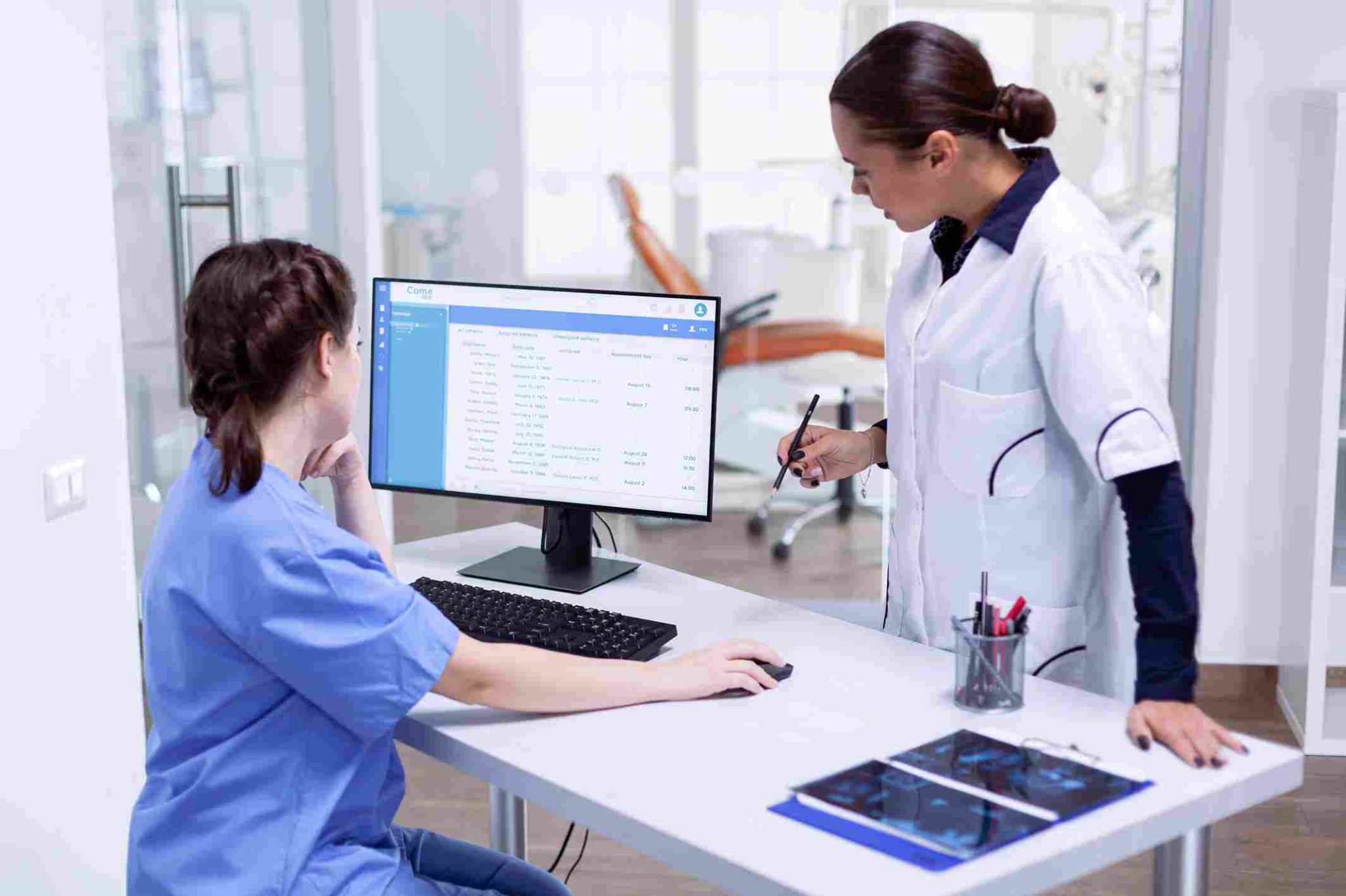 Healthcare worker using time tracking system at a computer