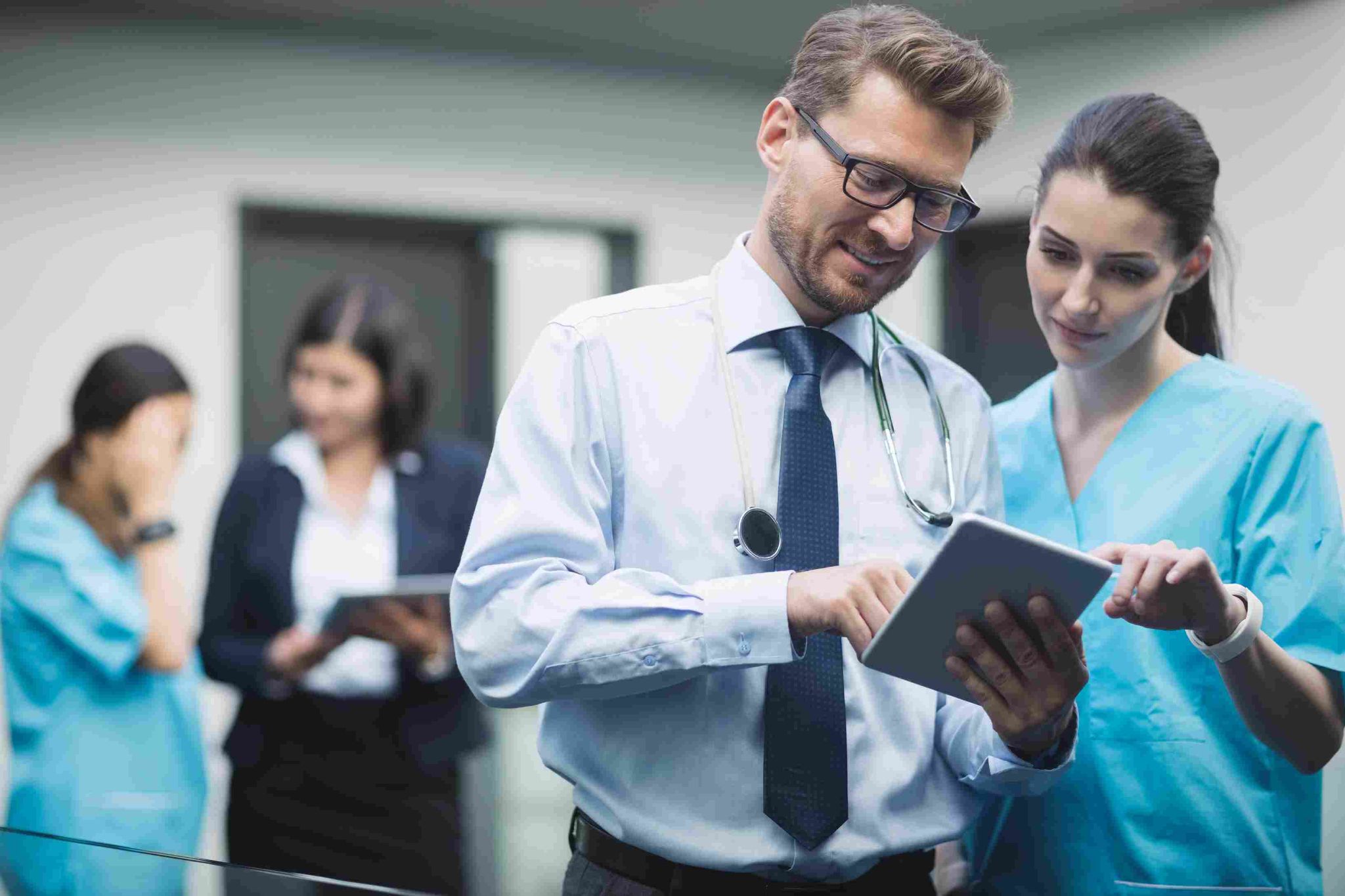 Doctors and nurses looking at a tablet