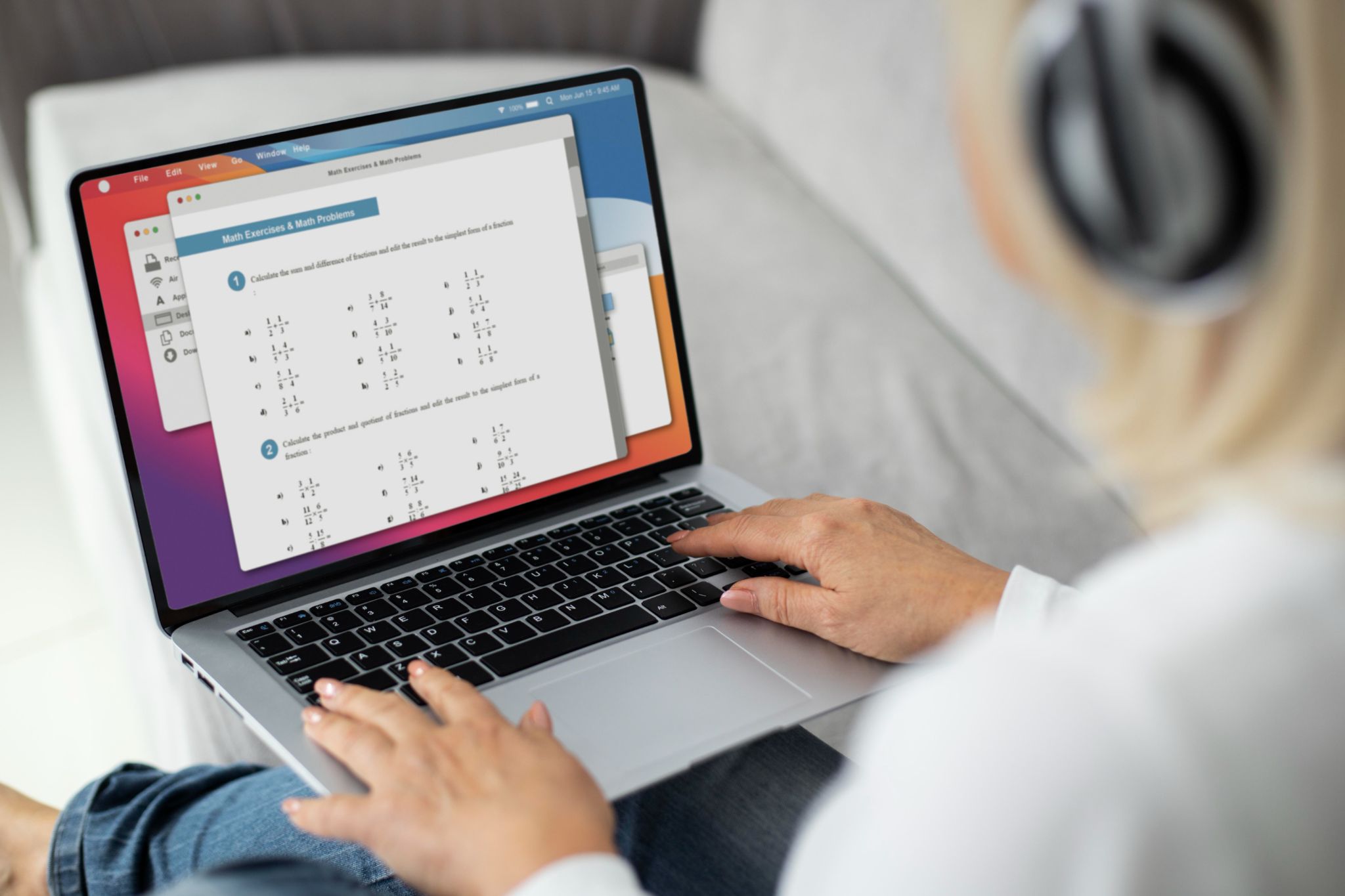 Close-up of hands typing on a laptop with a timesheet application open