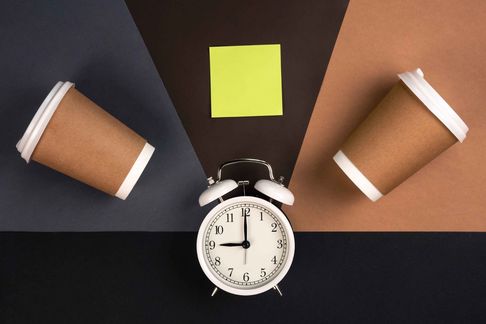 Two coffee cups and an alarm clock