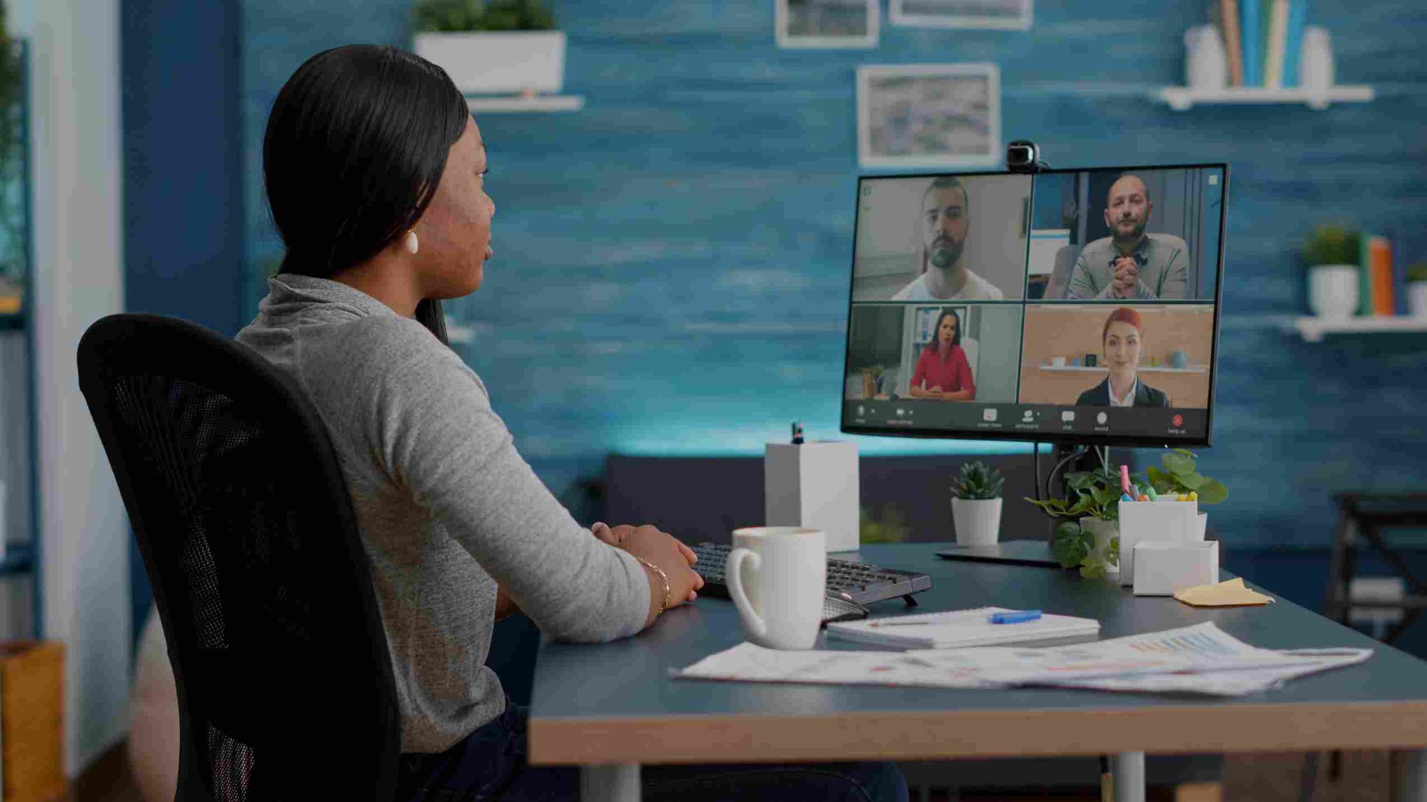 Woman working remotely on a laptop video call