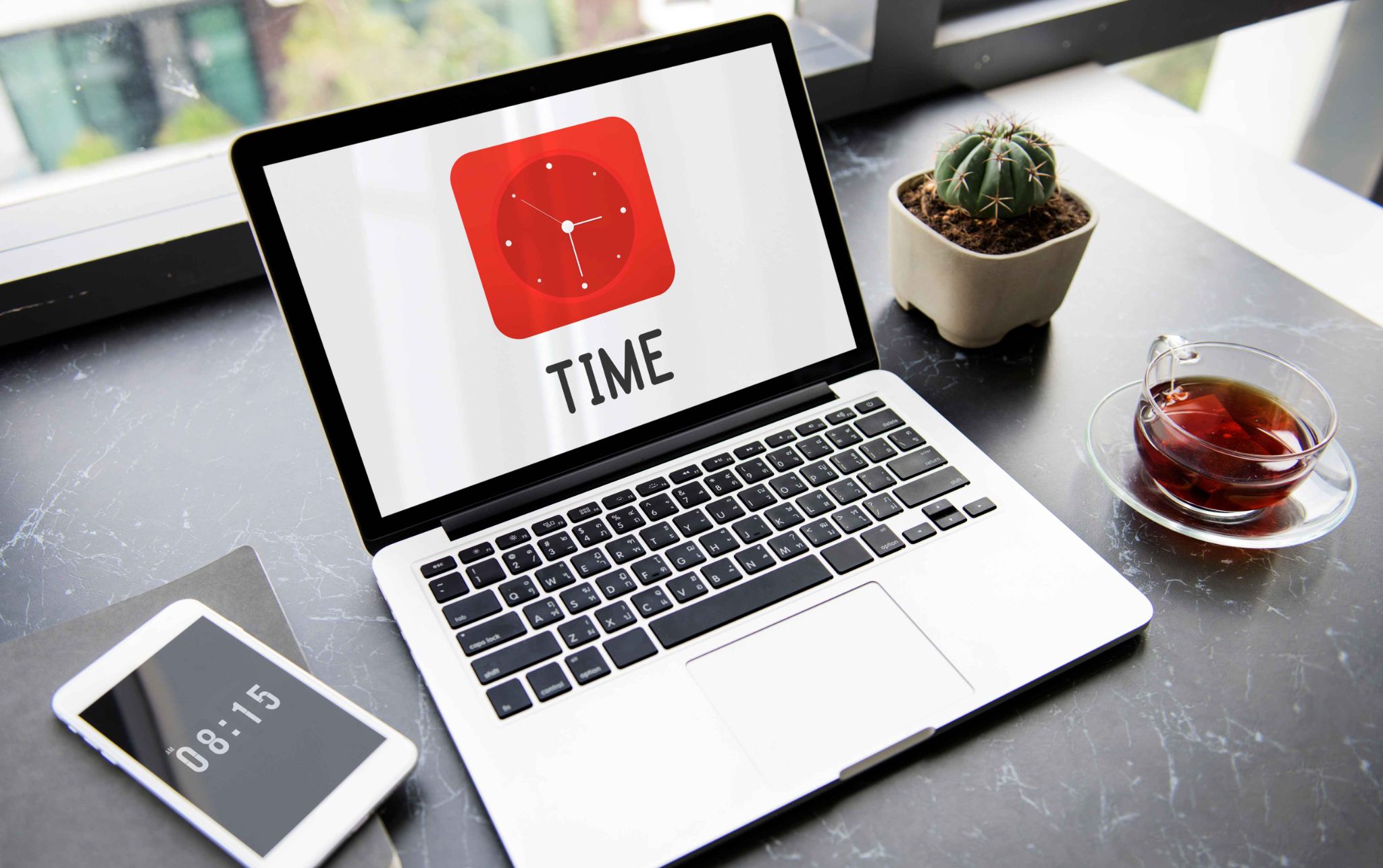 Laptop displaying a red clock icon with the word TIME