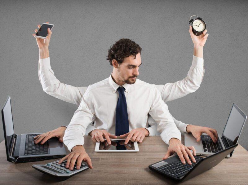 Multitasking employee managing time across multiple devices