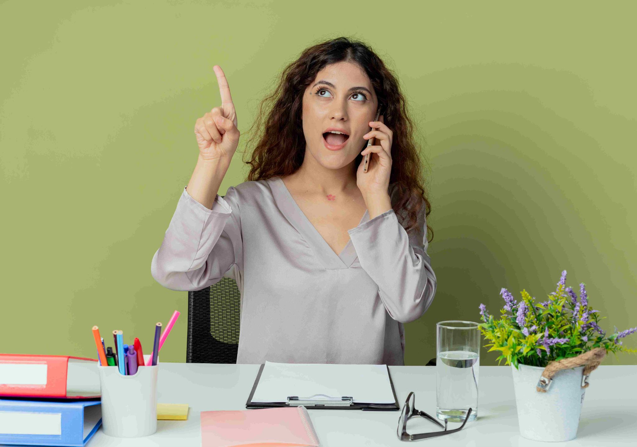 Woman pointing up while on the phone