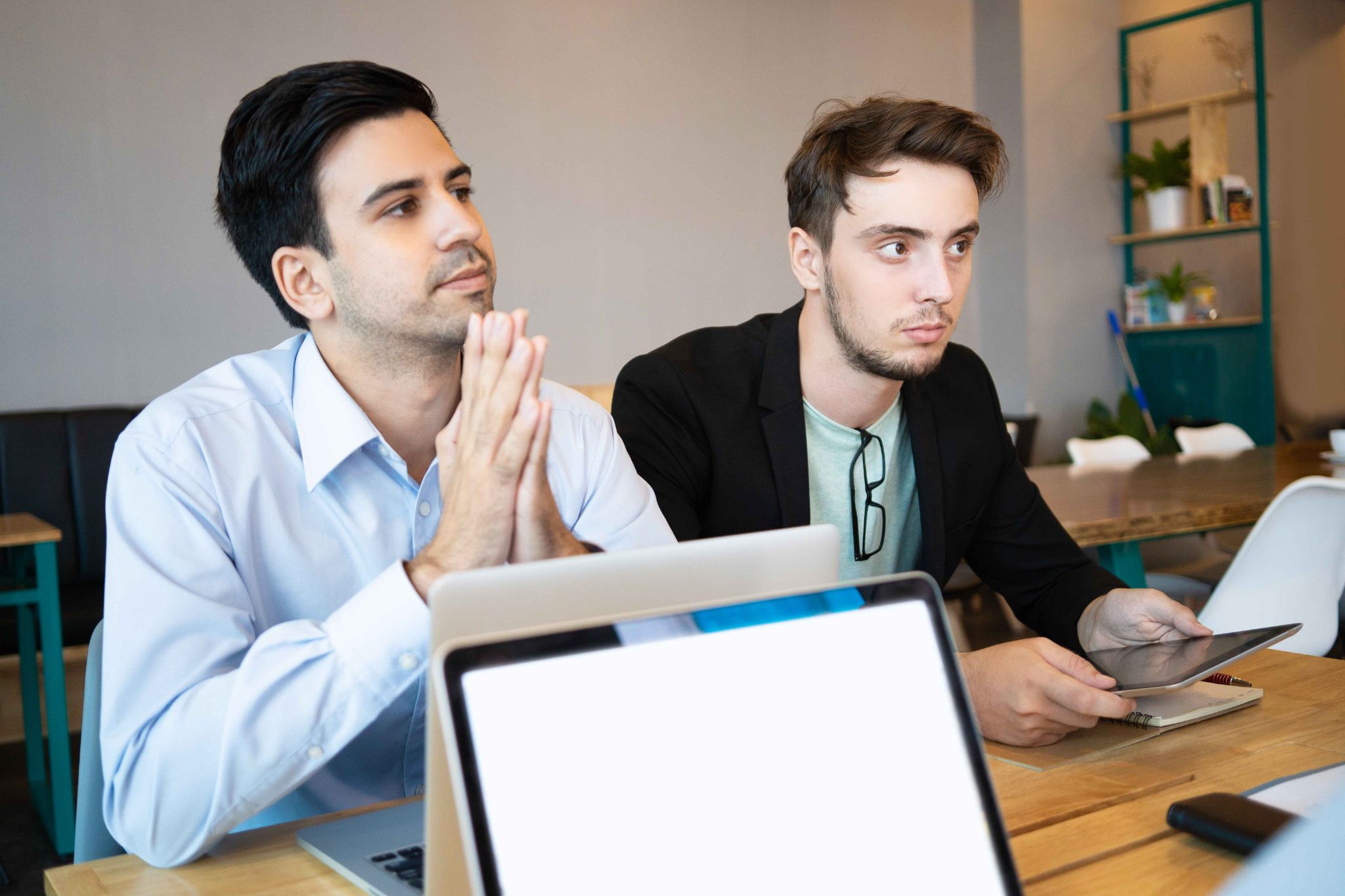 Two colleagues discussing work at a desk