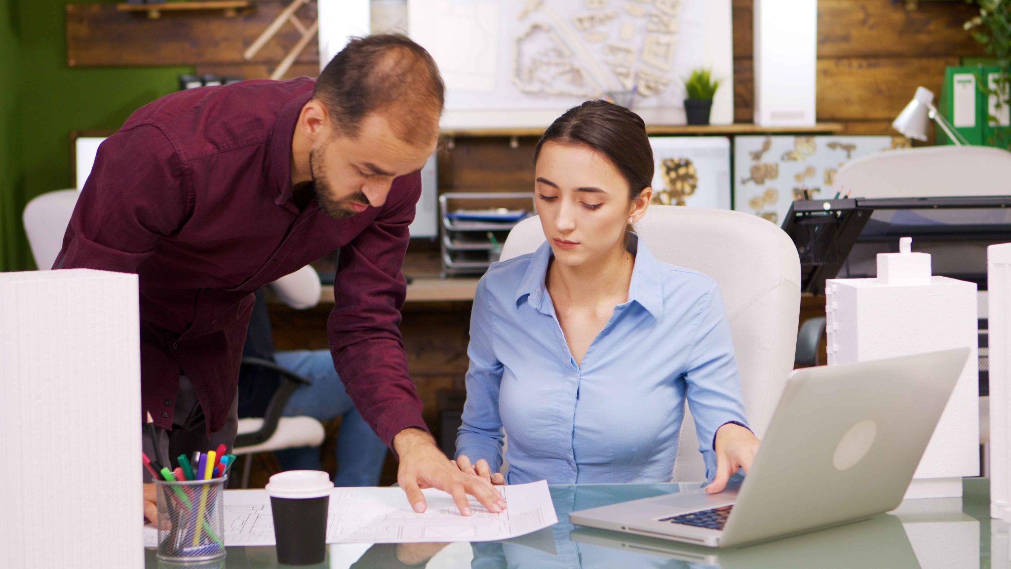 Business professionals looking at a payroll integration solution on a laptop