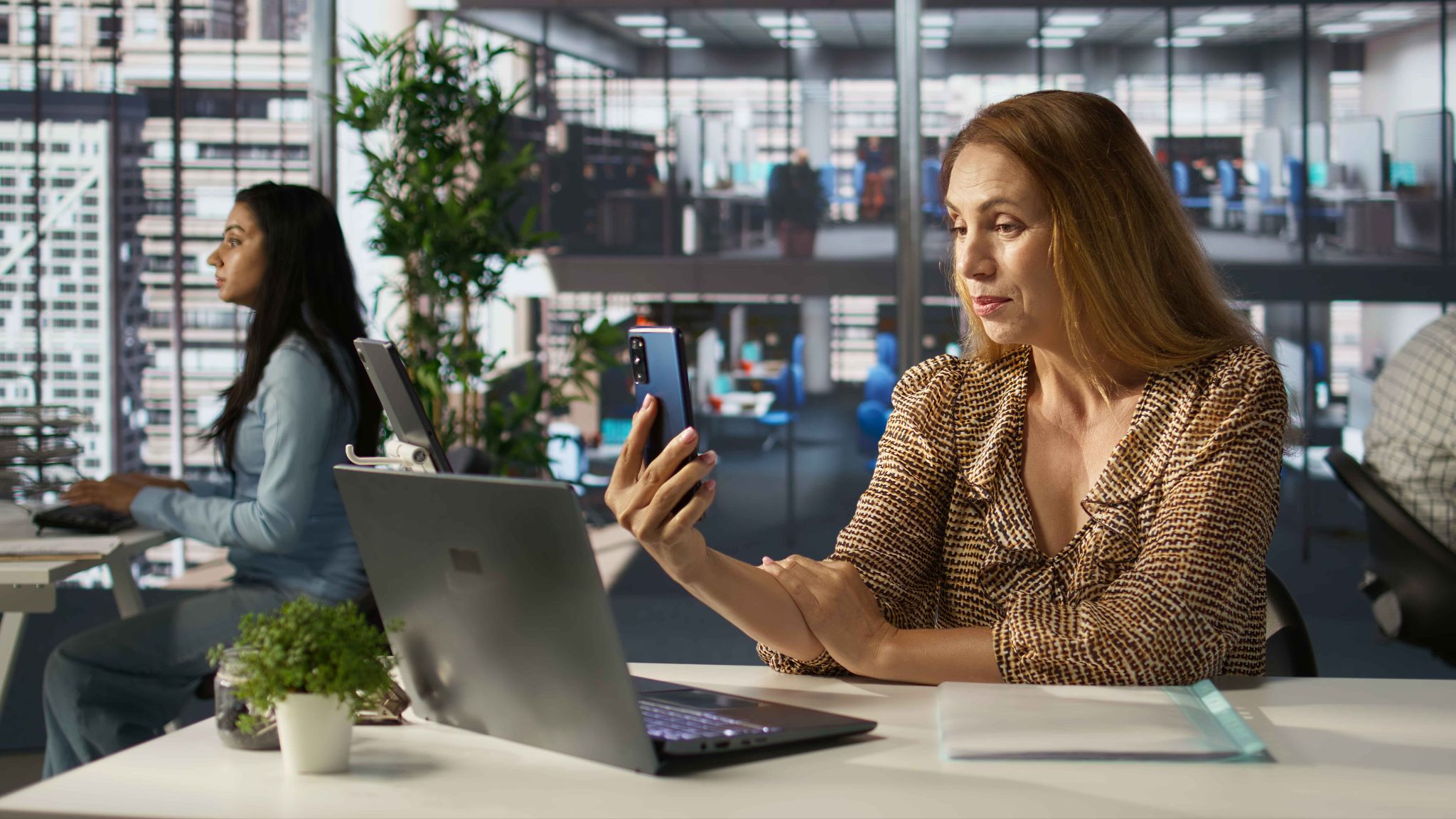 Woman in office using mobile phone
