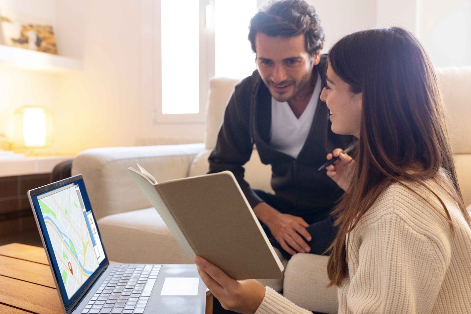 Colleagues discussing work on a laptop