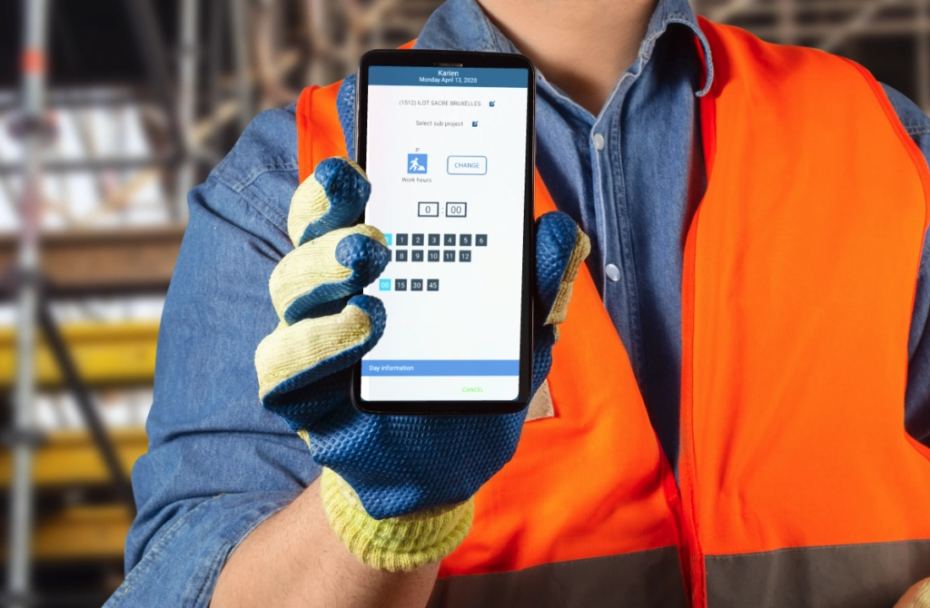 Construction worker holding a smartphone with time tracking app